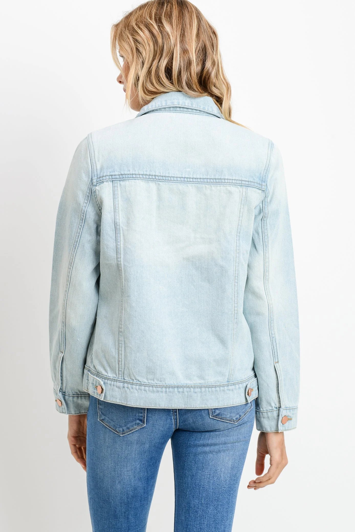 Light blue denim jacket worn by a person on a white background