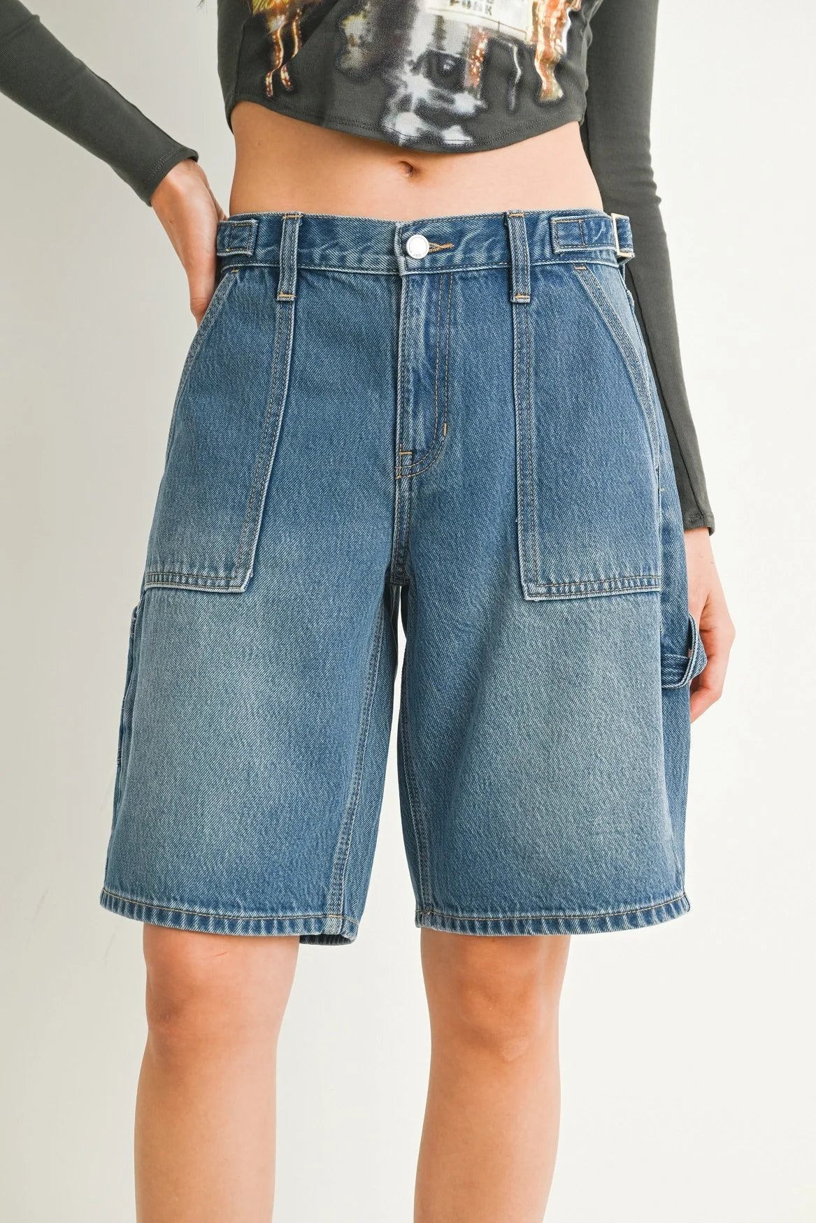 Woman modeling denim on a white background.