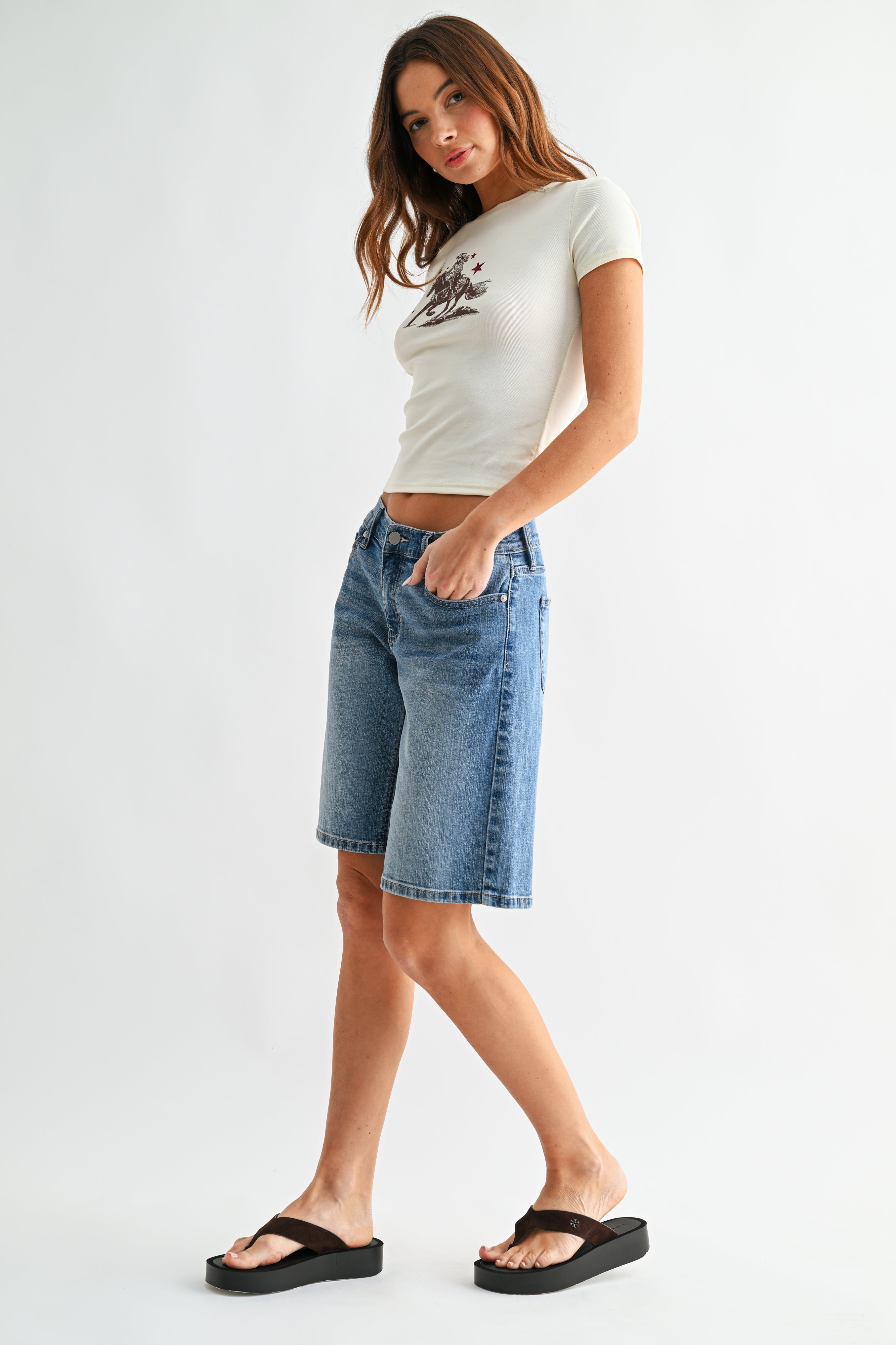 Woman modeling denim shorts.