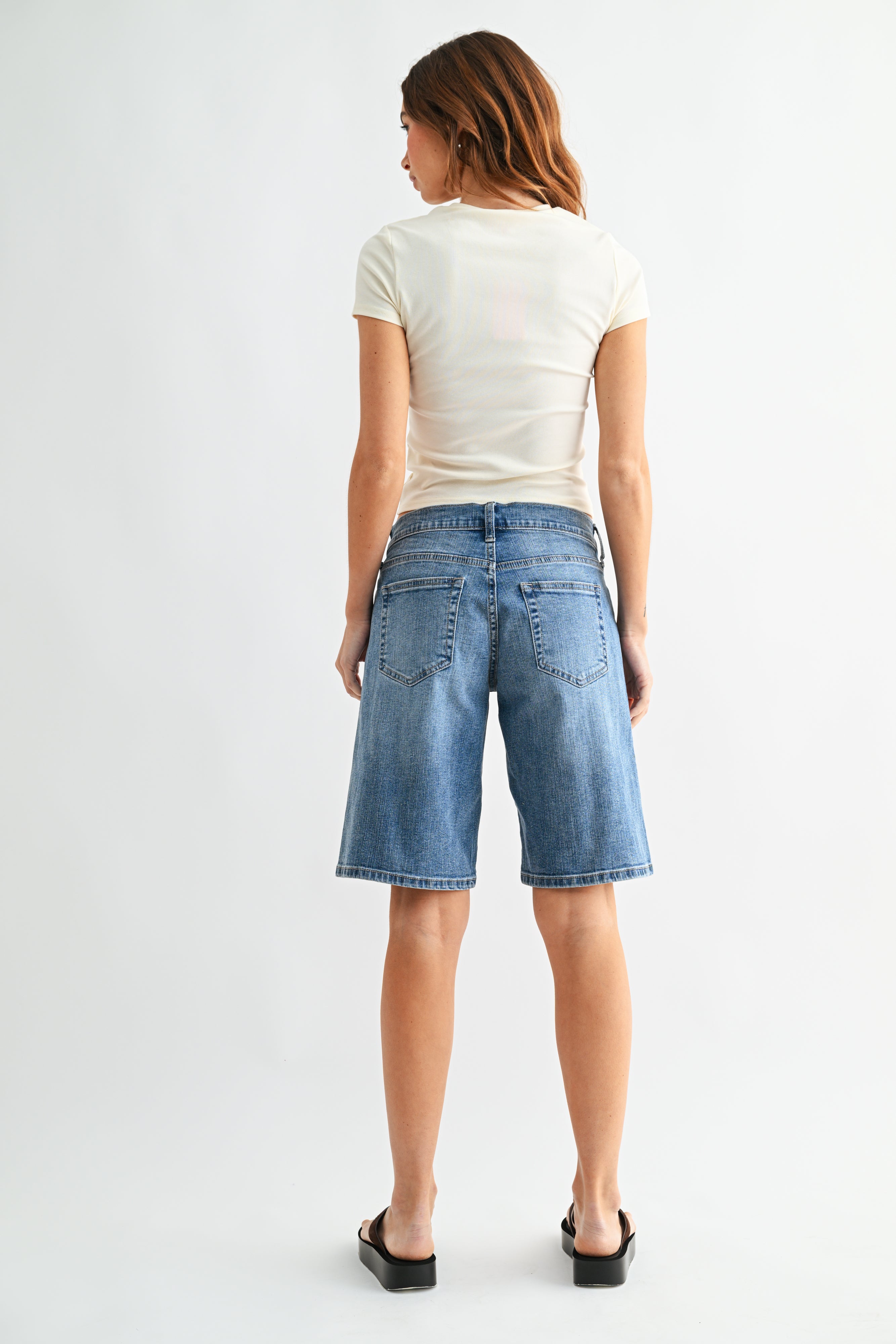 Woman modeling denim shorts.
