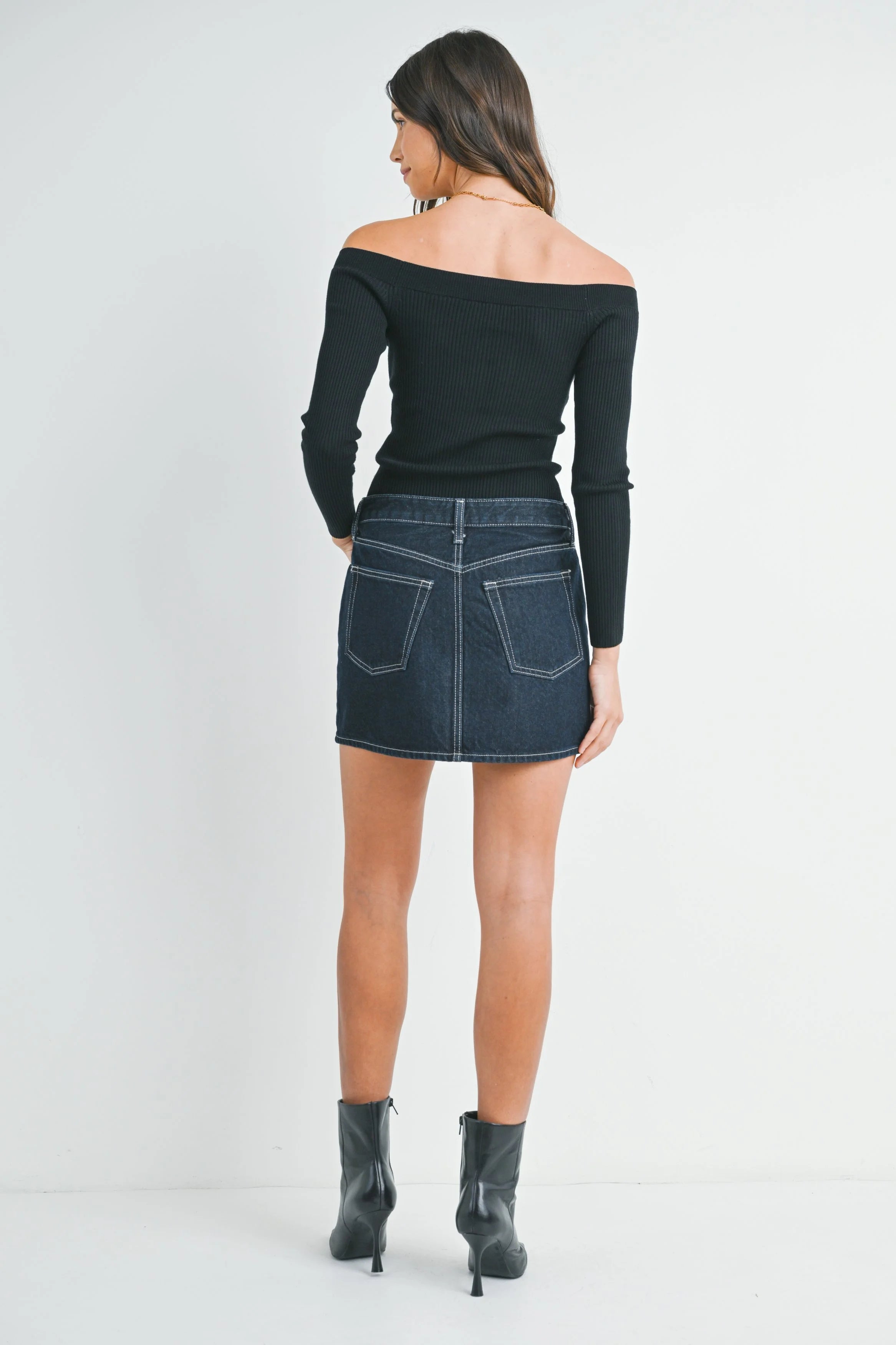 Woman modeling denim on a white background.