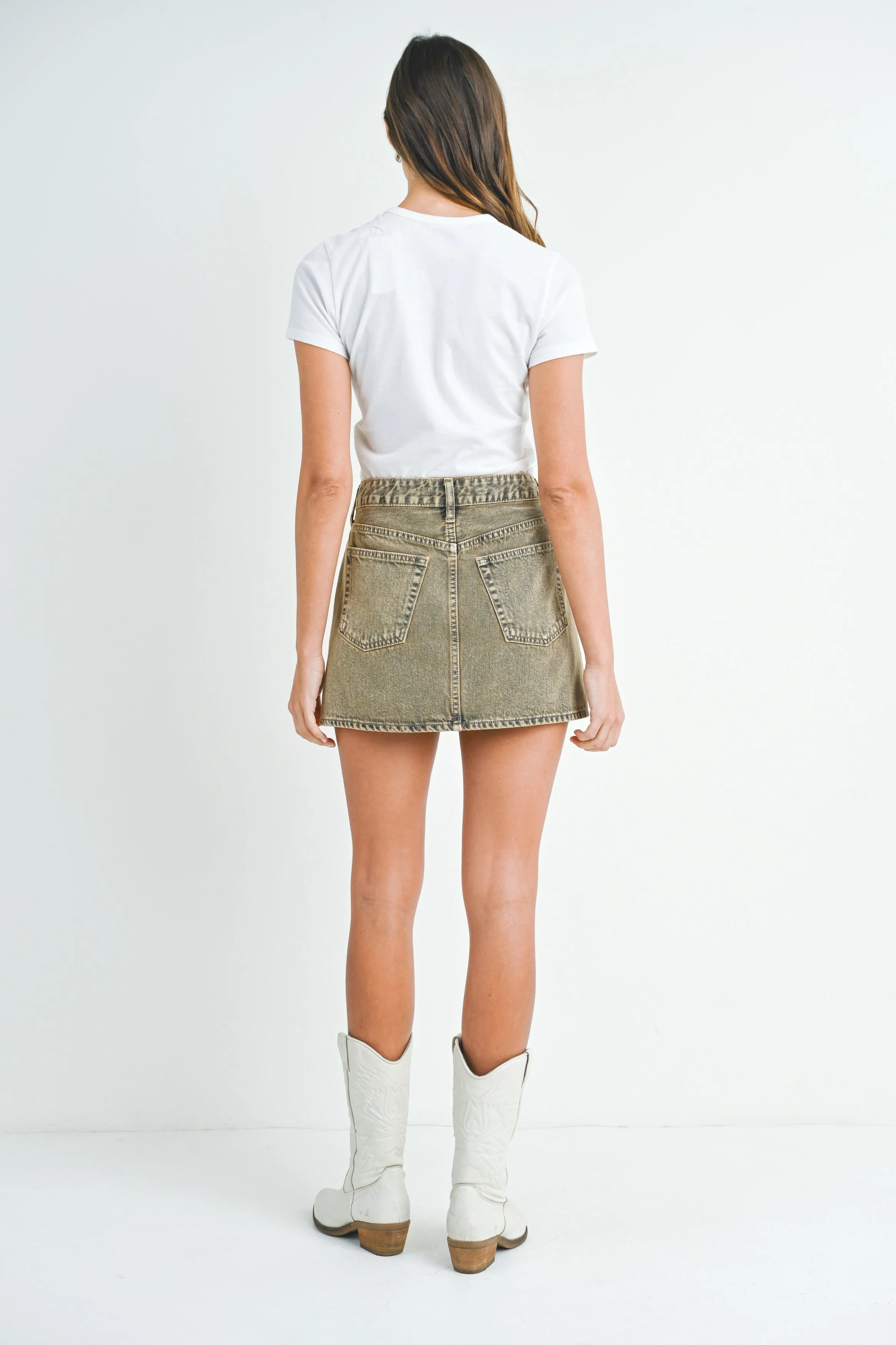 Woman modeling denim on a white background.