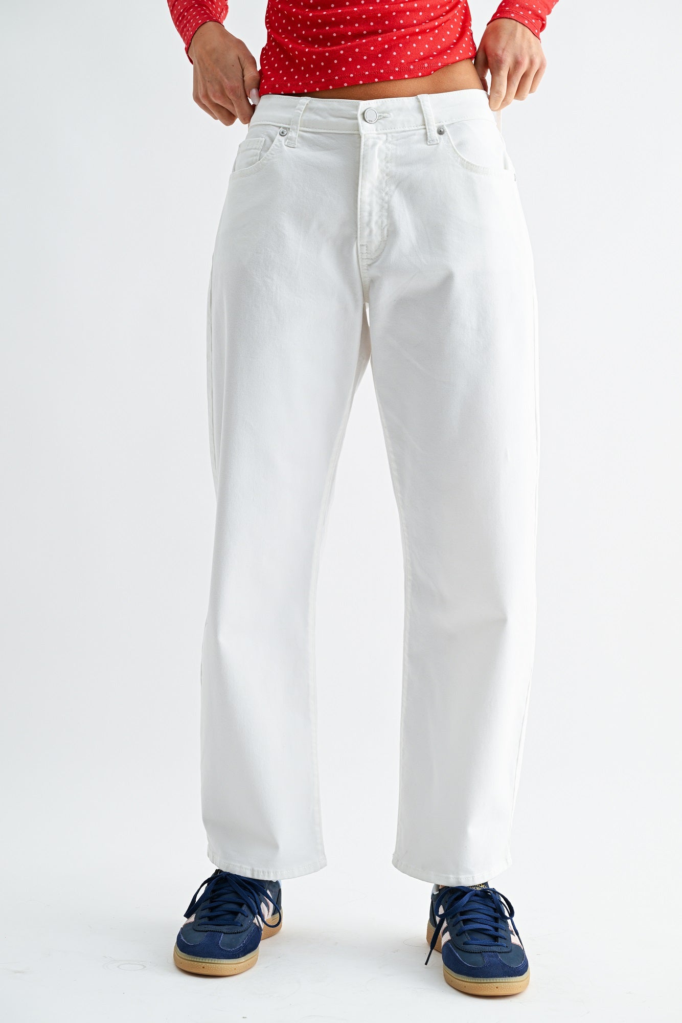 White pants worn by a person on a white background