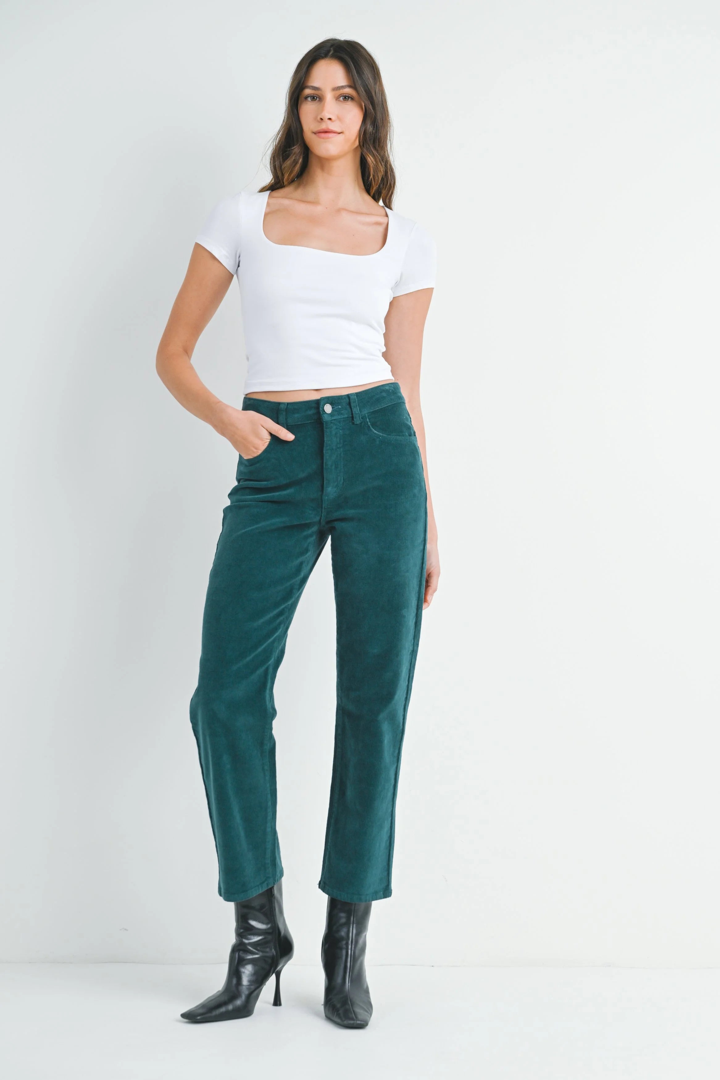 Woman modeling denim on a white background.