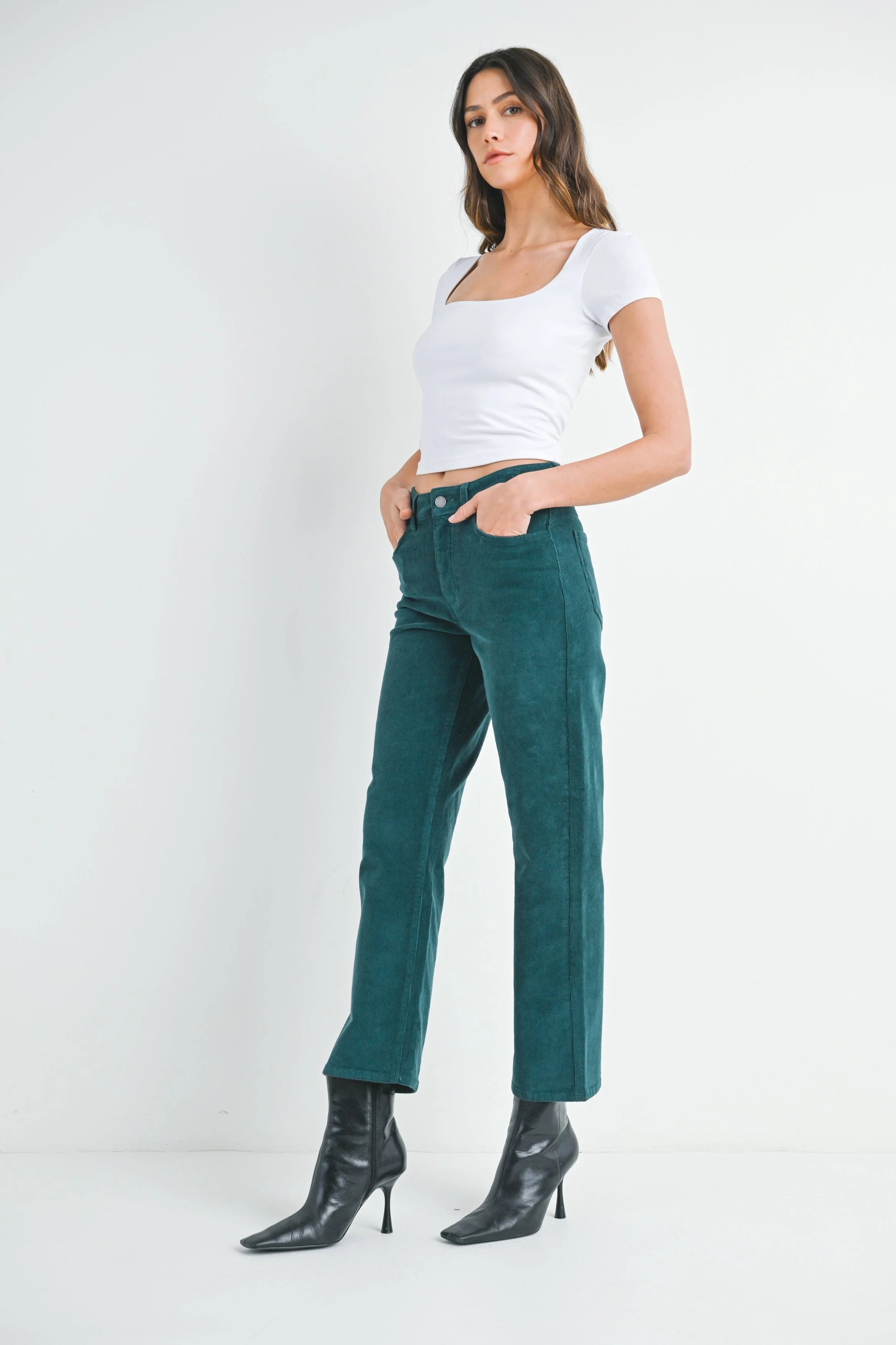 Woman modeling denim on a white background.