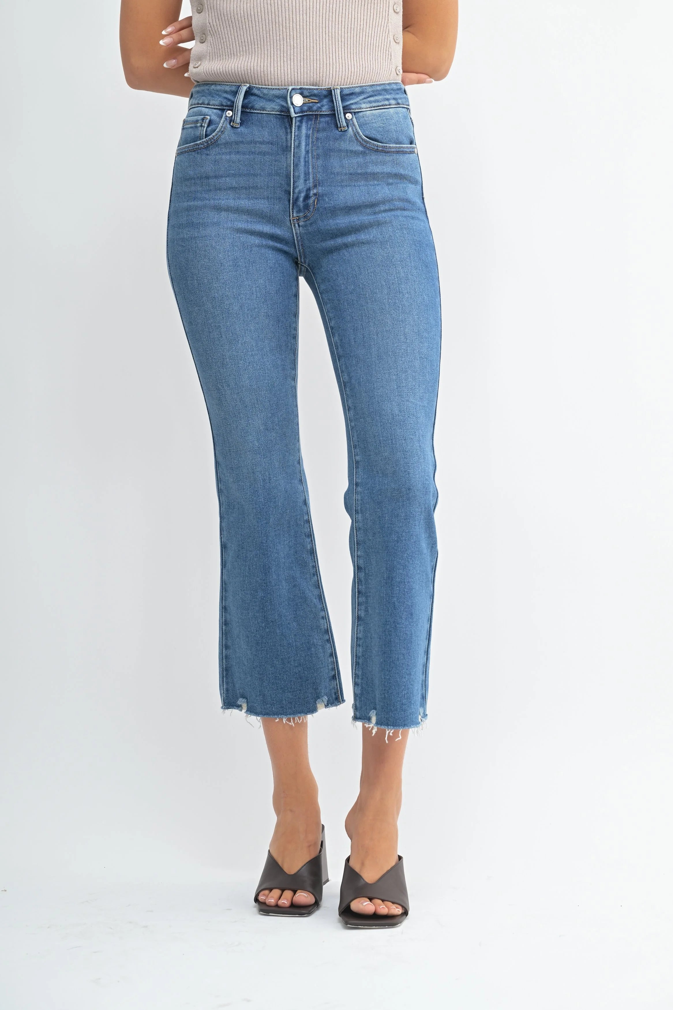 Person wearing blue jeans on a white background
