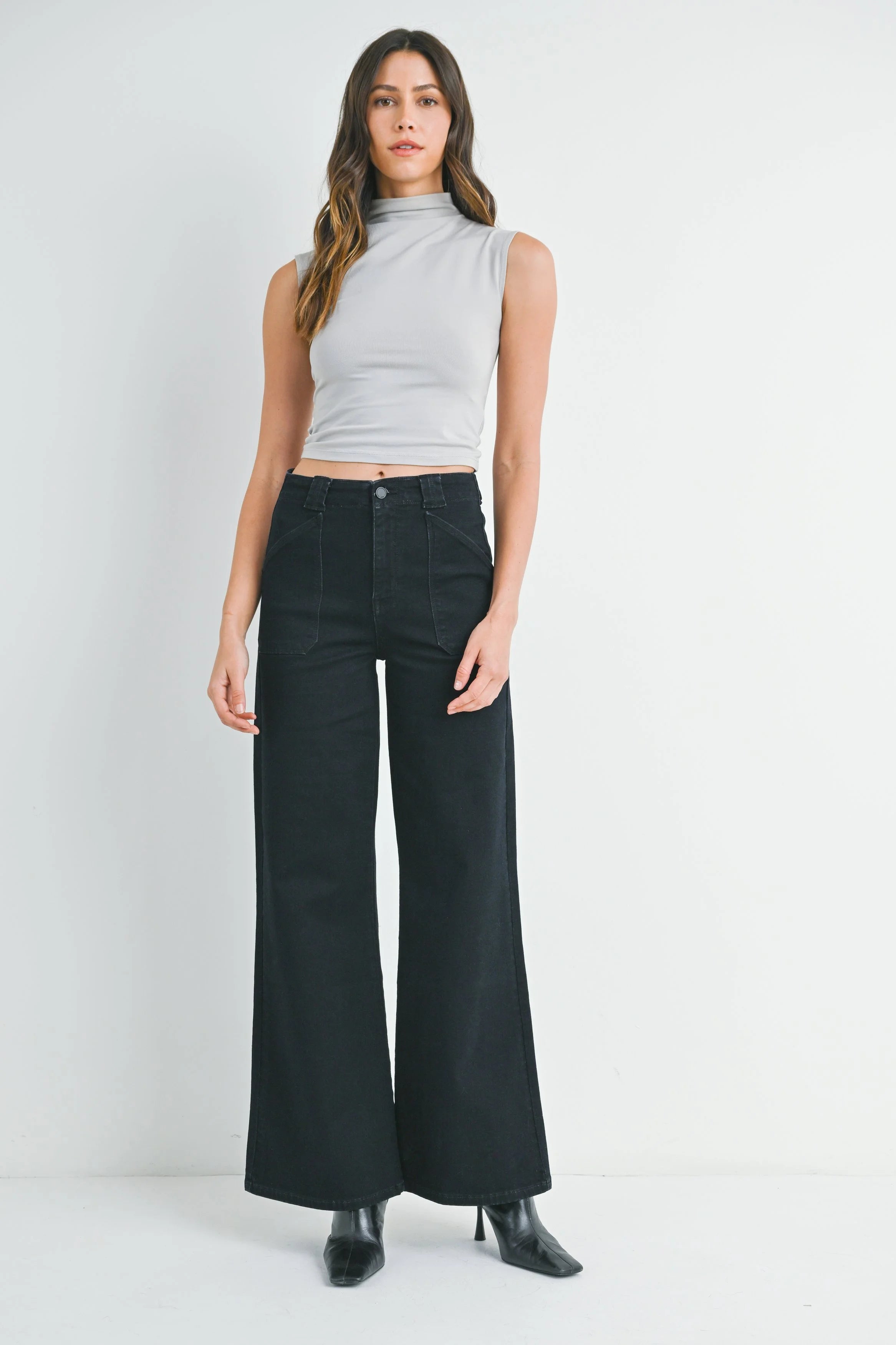 Woman modeling denim on a white background.