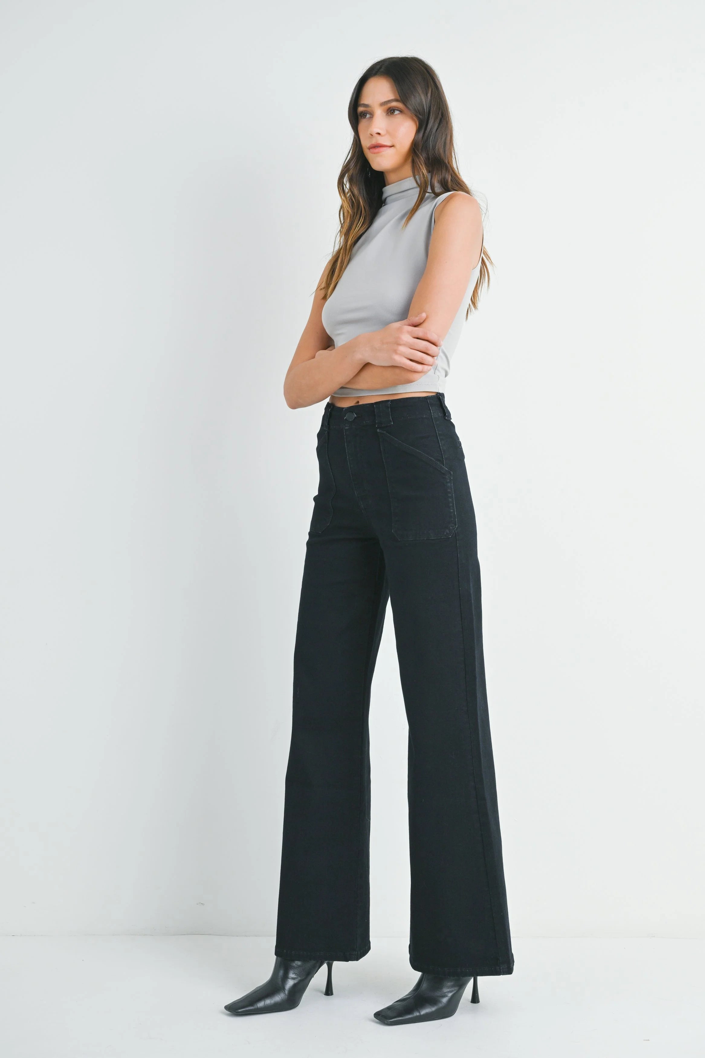 Woman modeling denim on a white background.