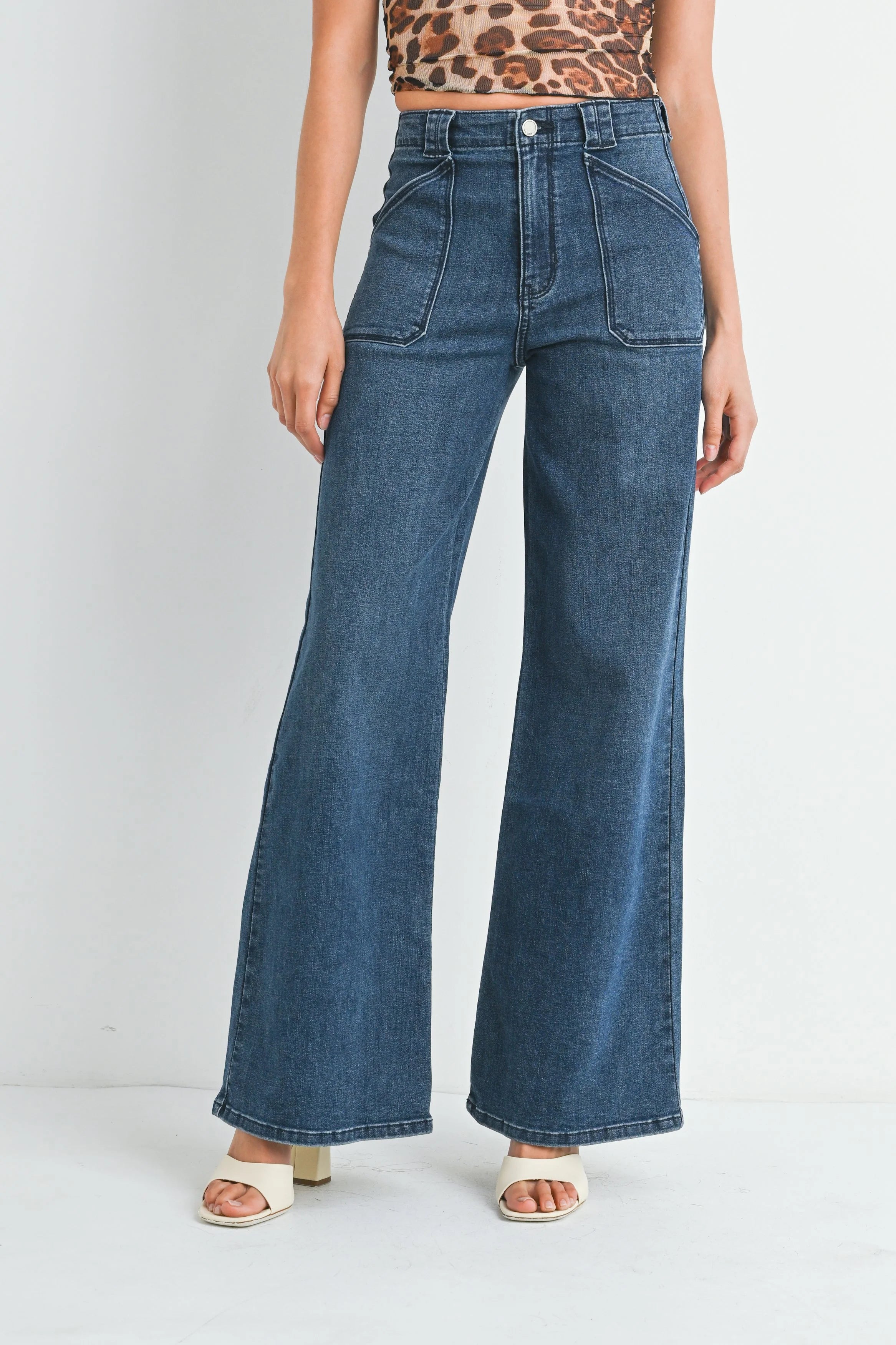 Woman modeling denim on a white background.