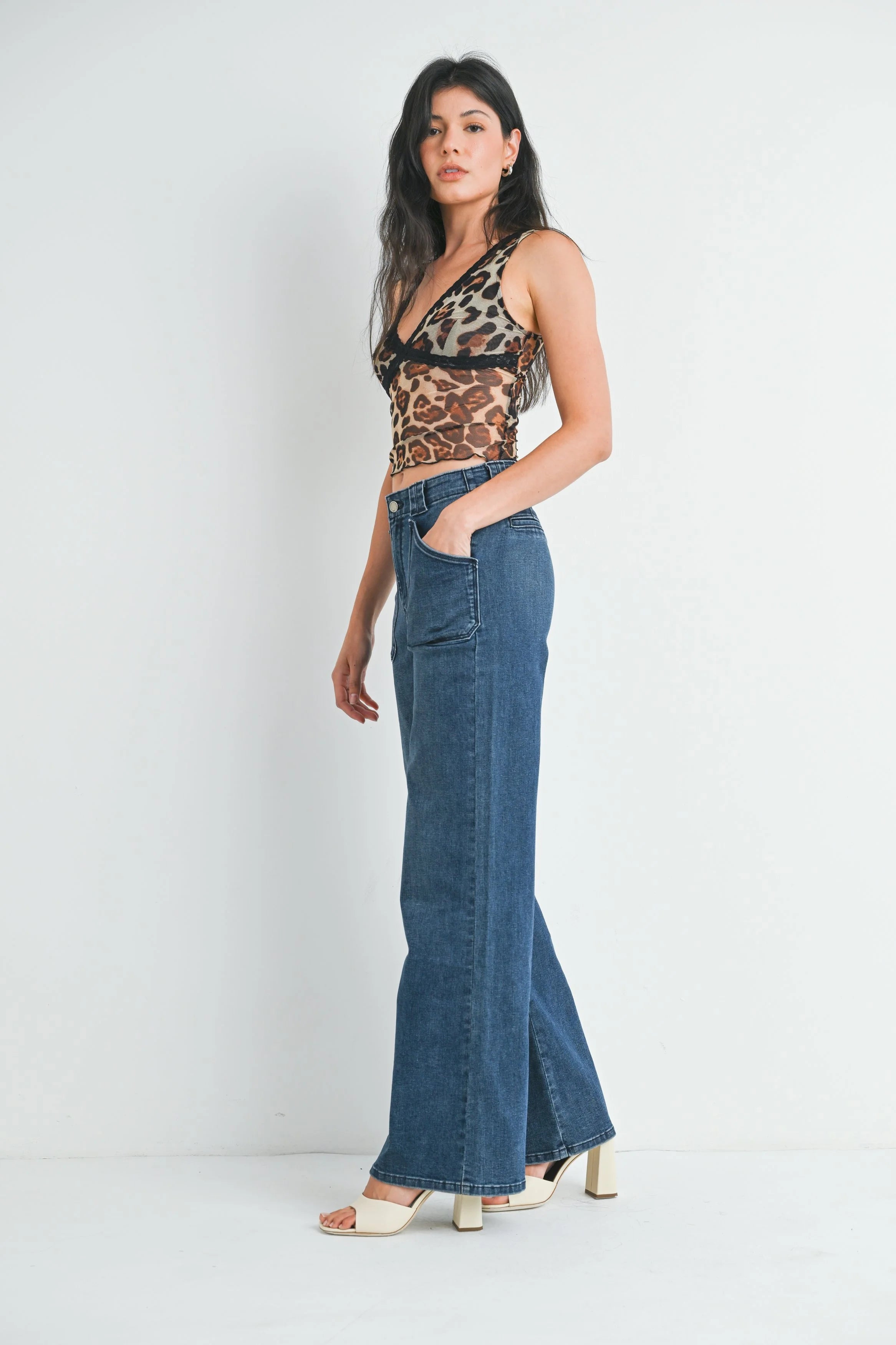 Woman modeling denim on a white background.