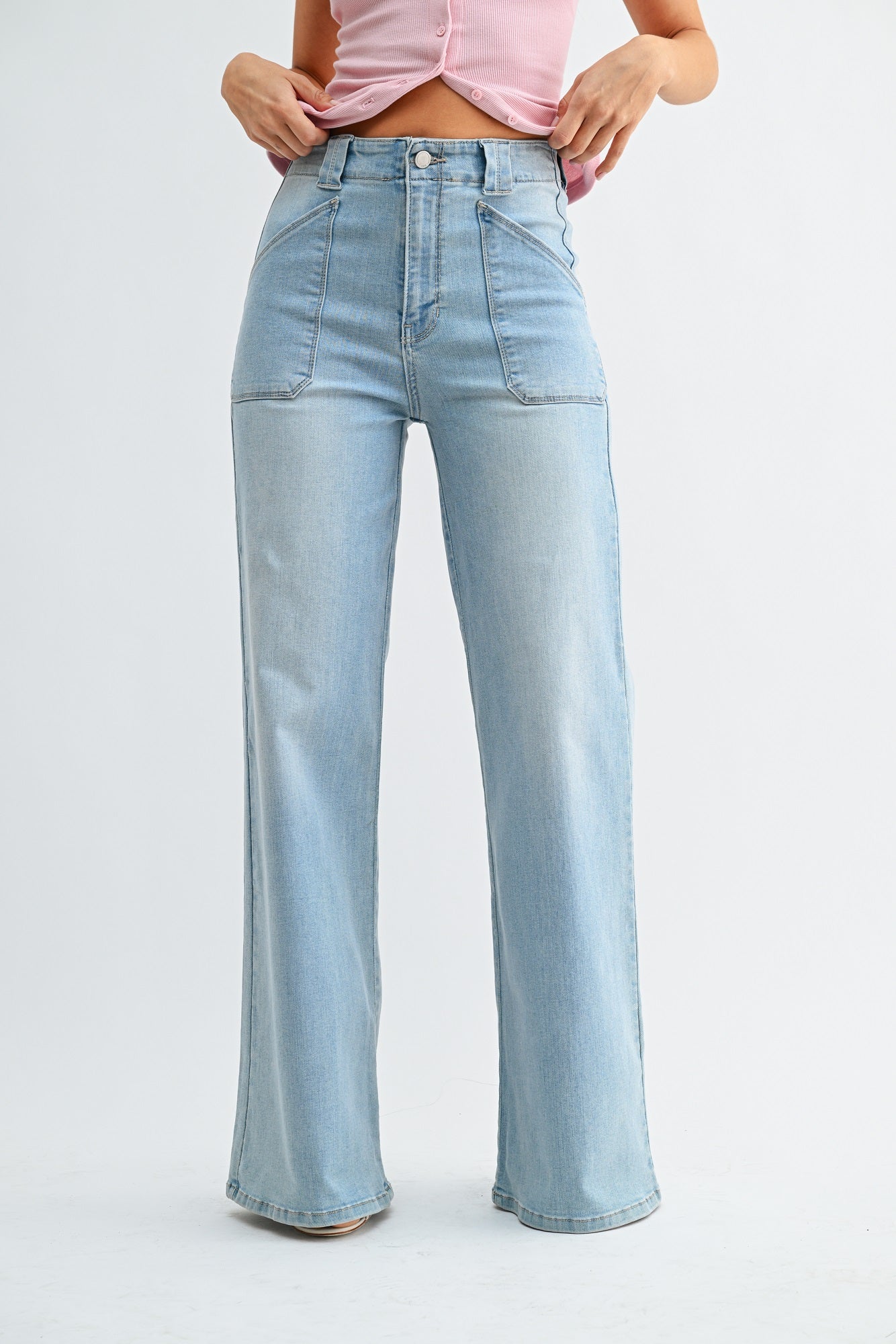 Light blue jeans worn by a person on a white background