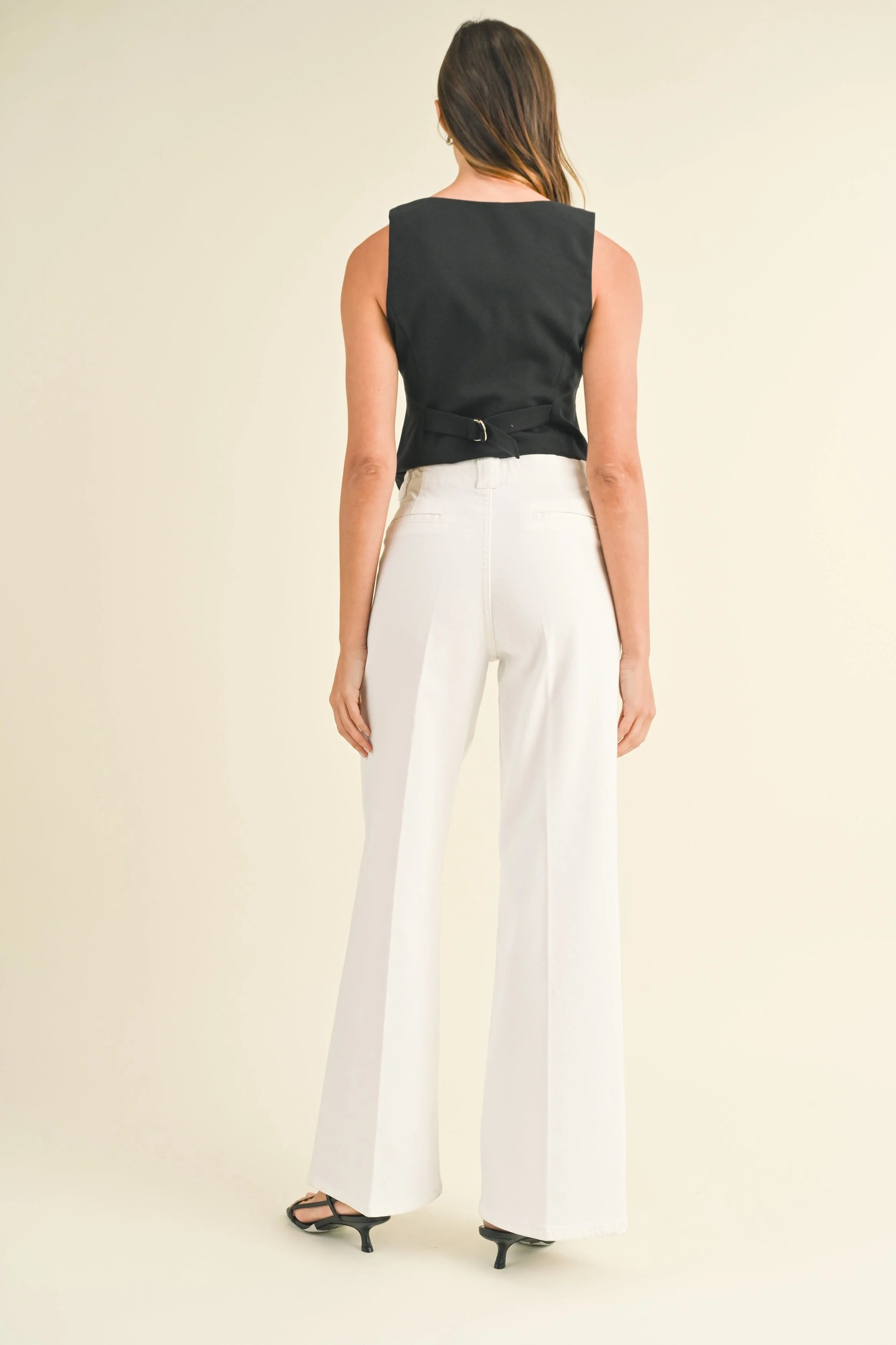 Woman modeling denim on a white background.