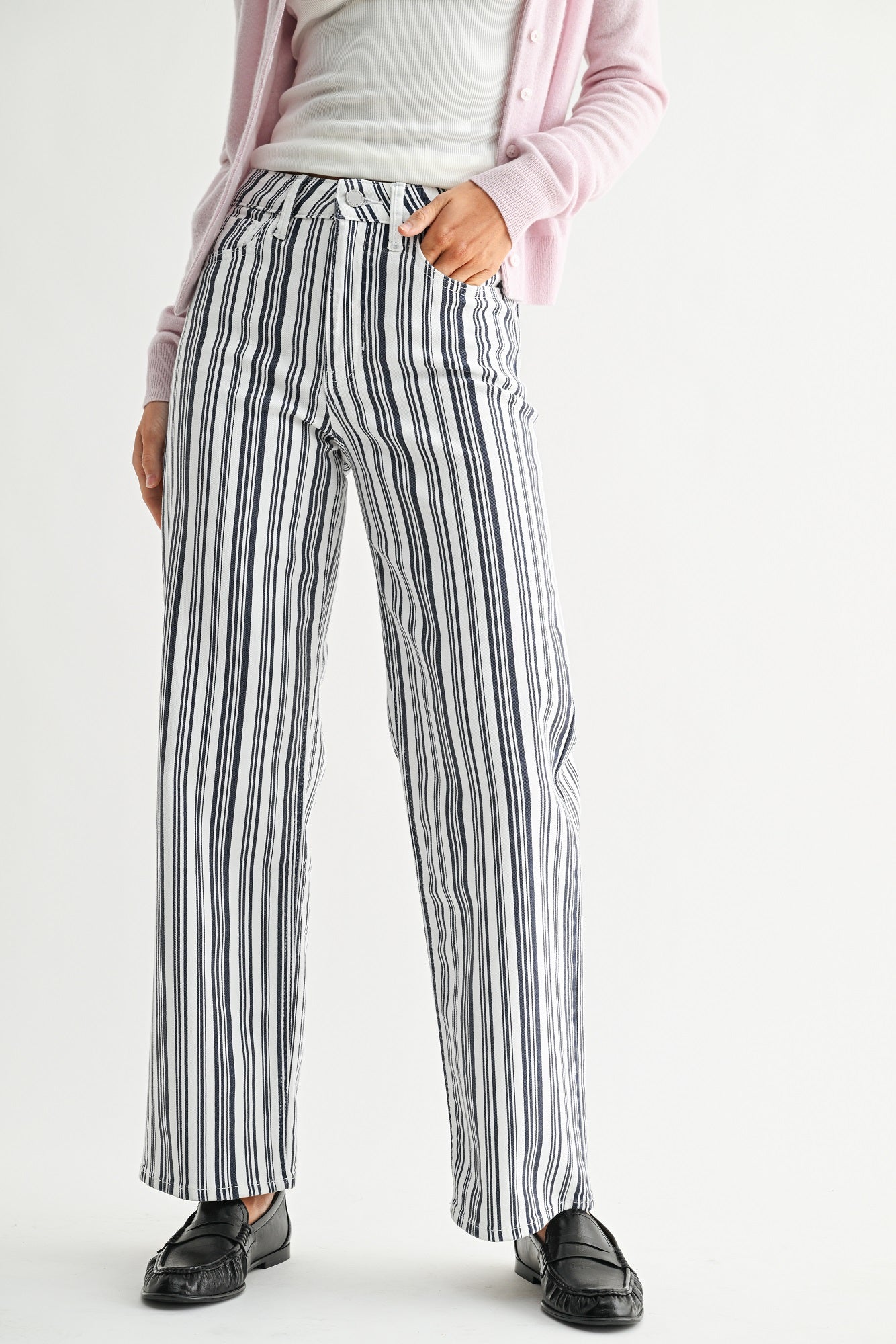 Person wearing striped pants with a plain background