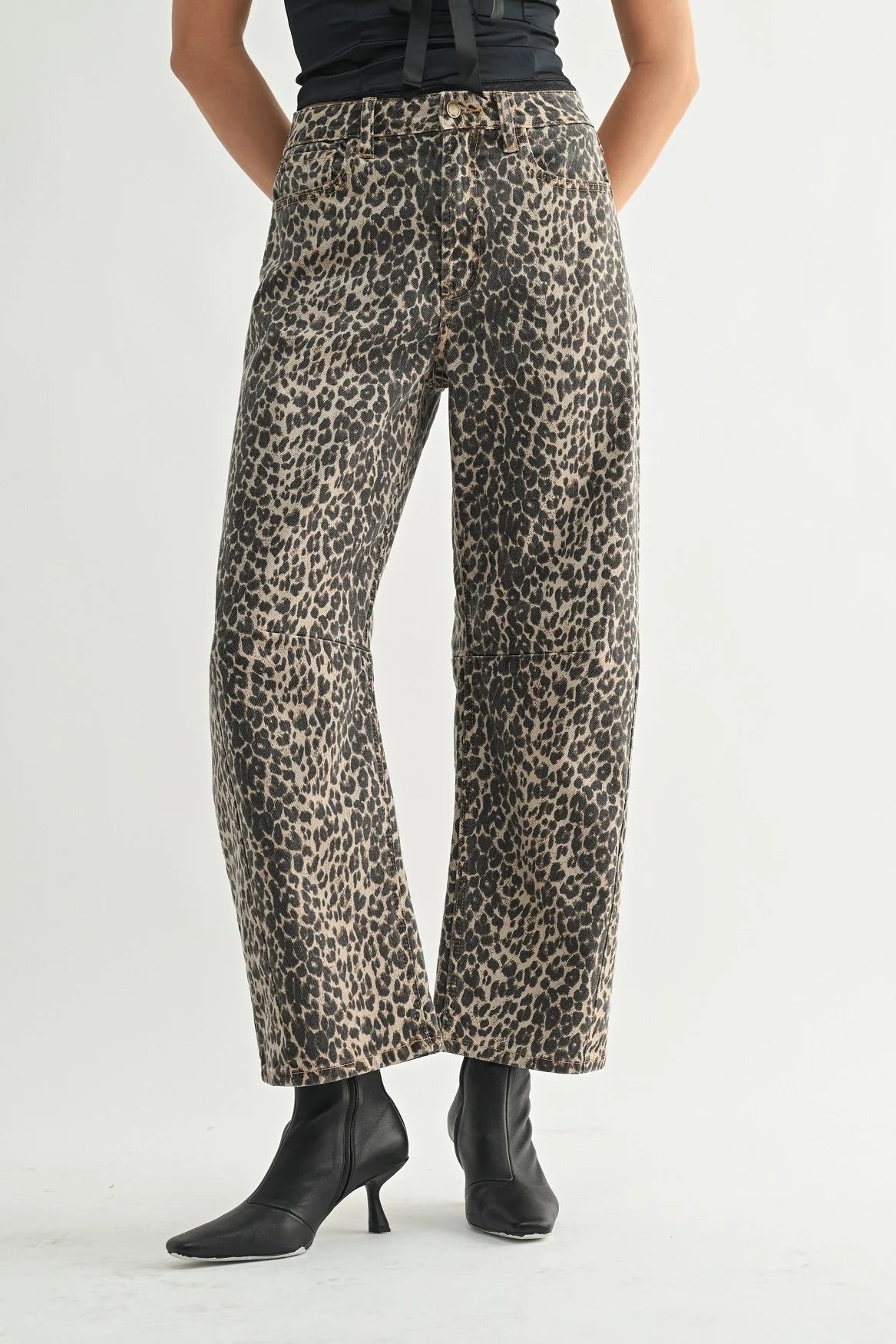 Leopard print pants worn by a person on a white background