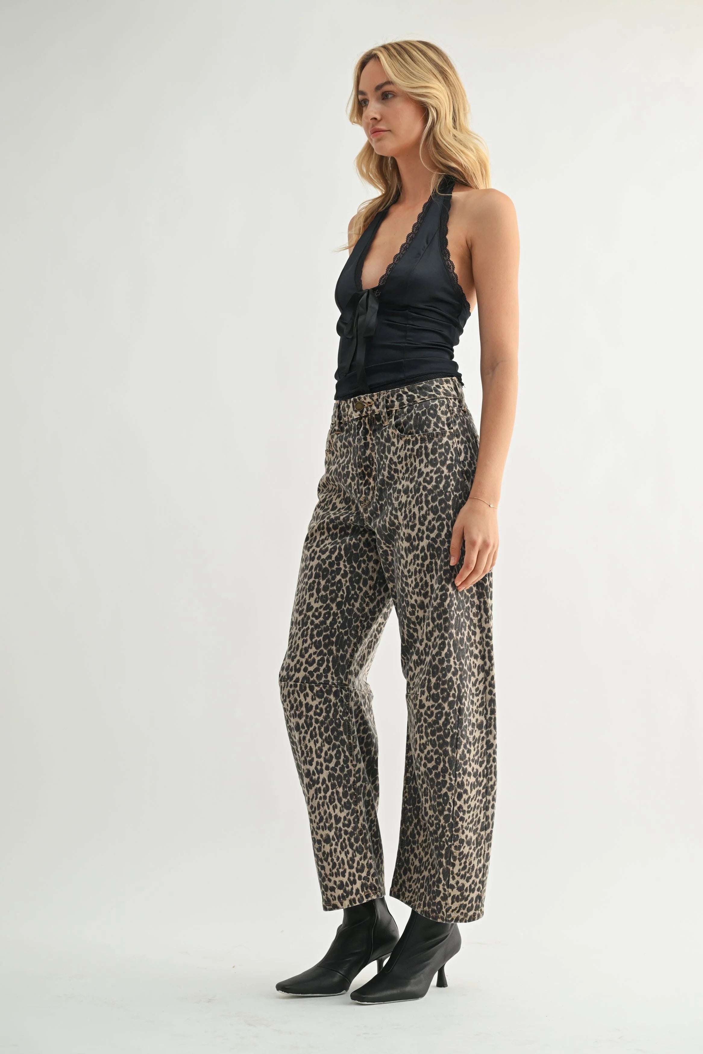 Woman modeling denim on a white background.