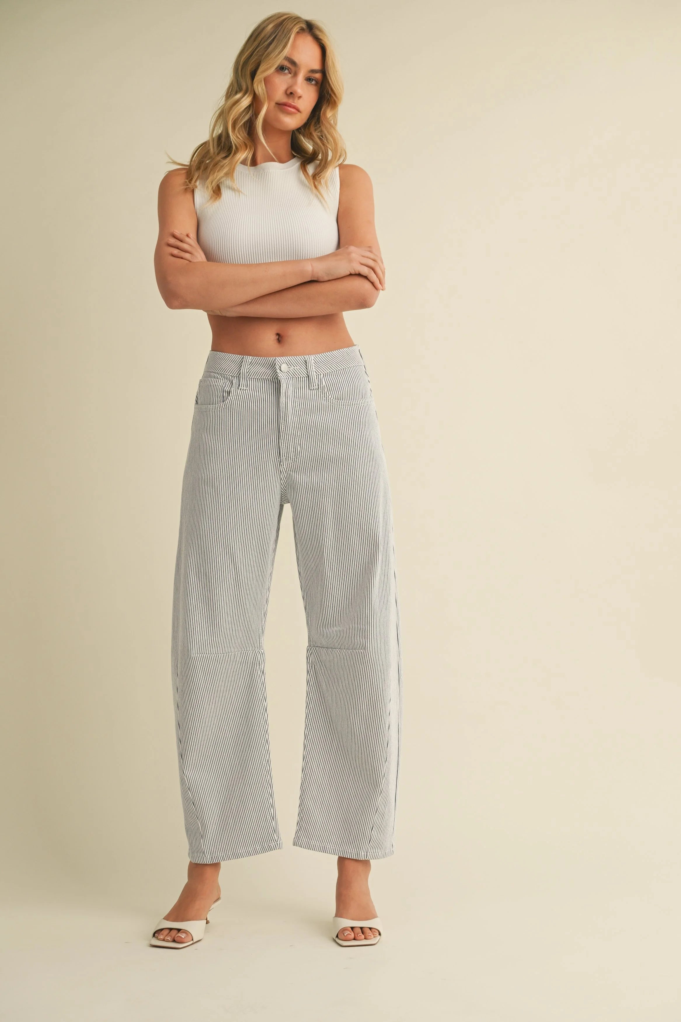 Woman modeling denim on a white background.