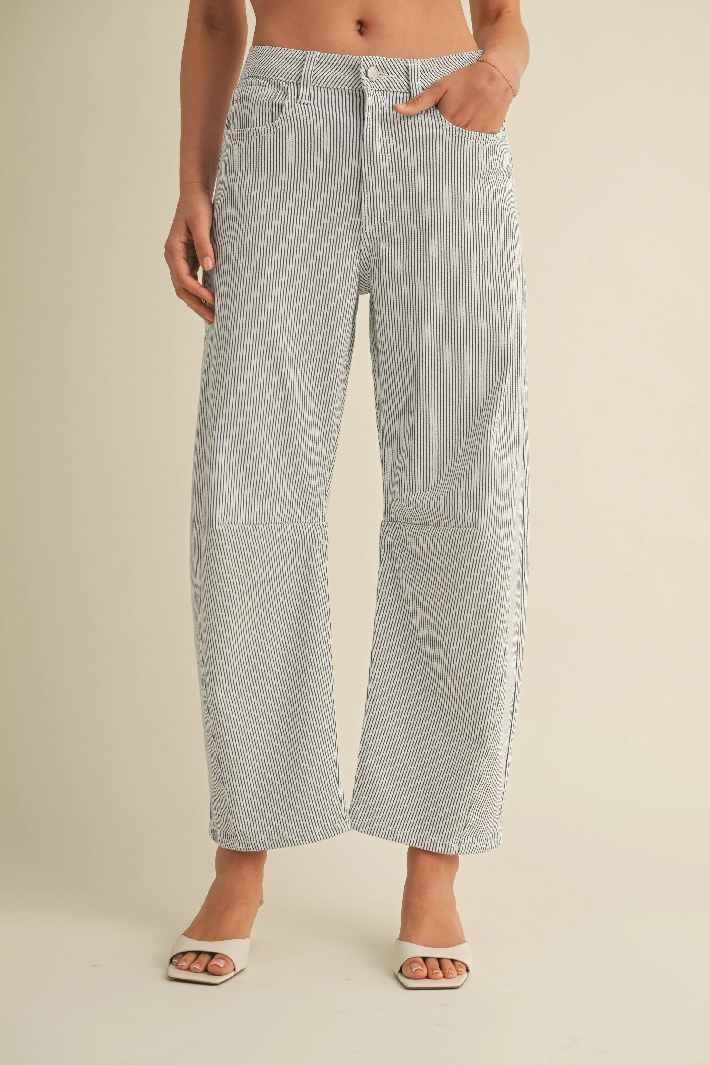Woman modeling denim on a white background.