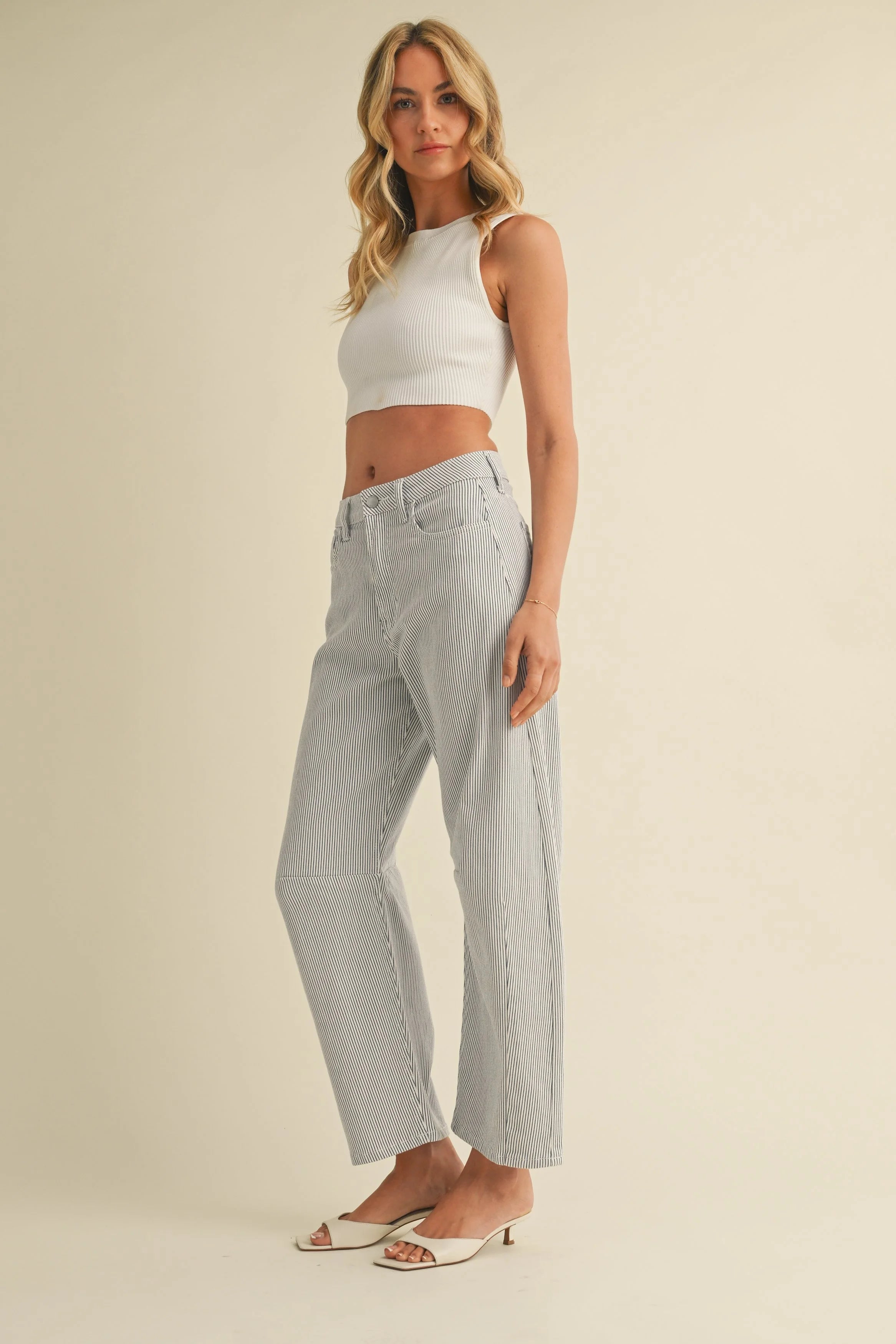 Woman modeling denim on a white background.