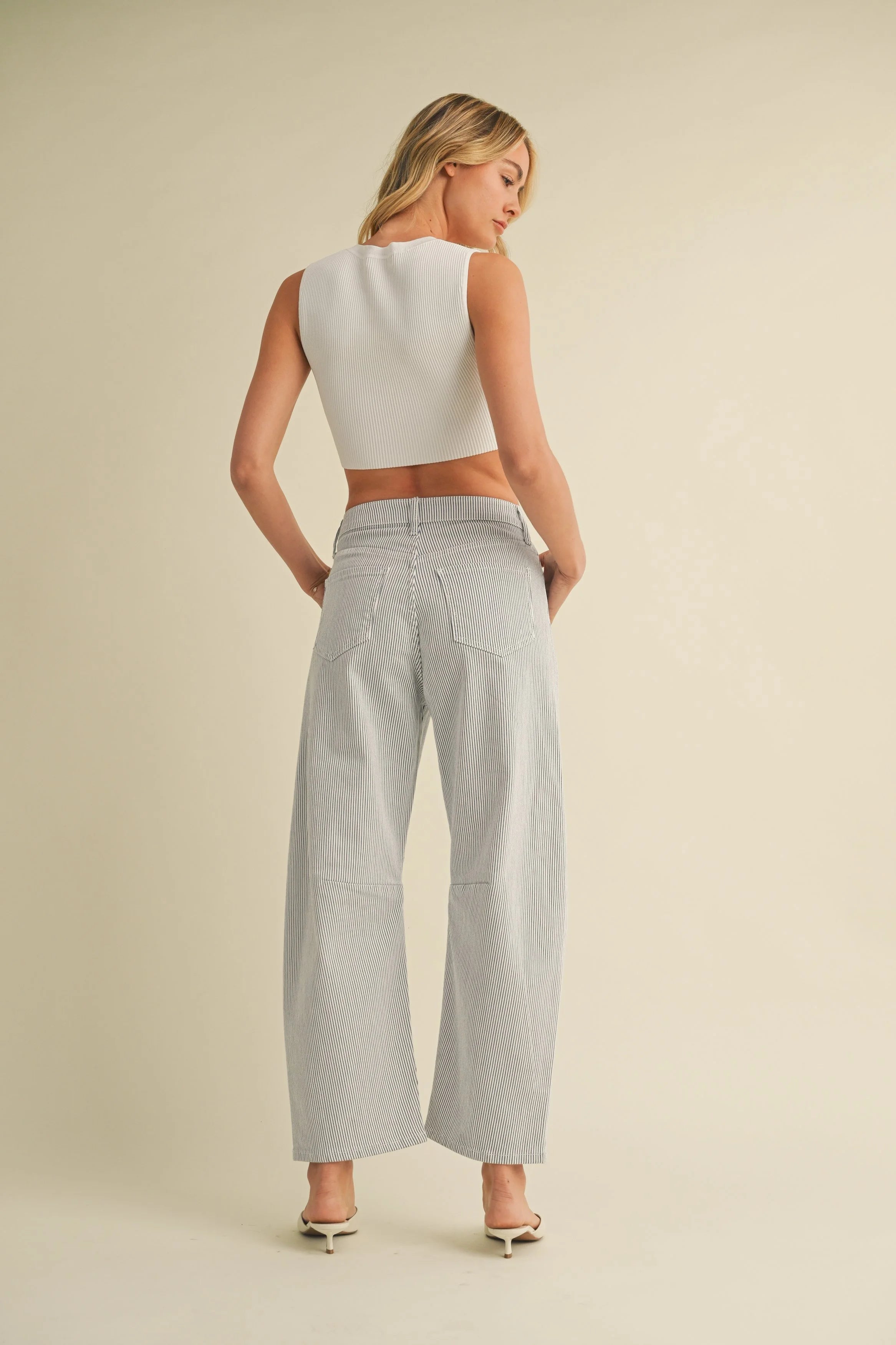 Woman modeling denim on a white background.