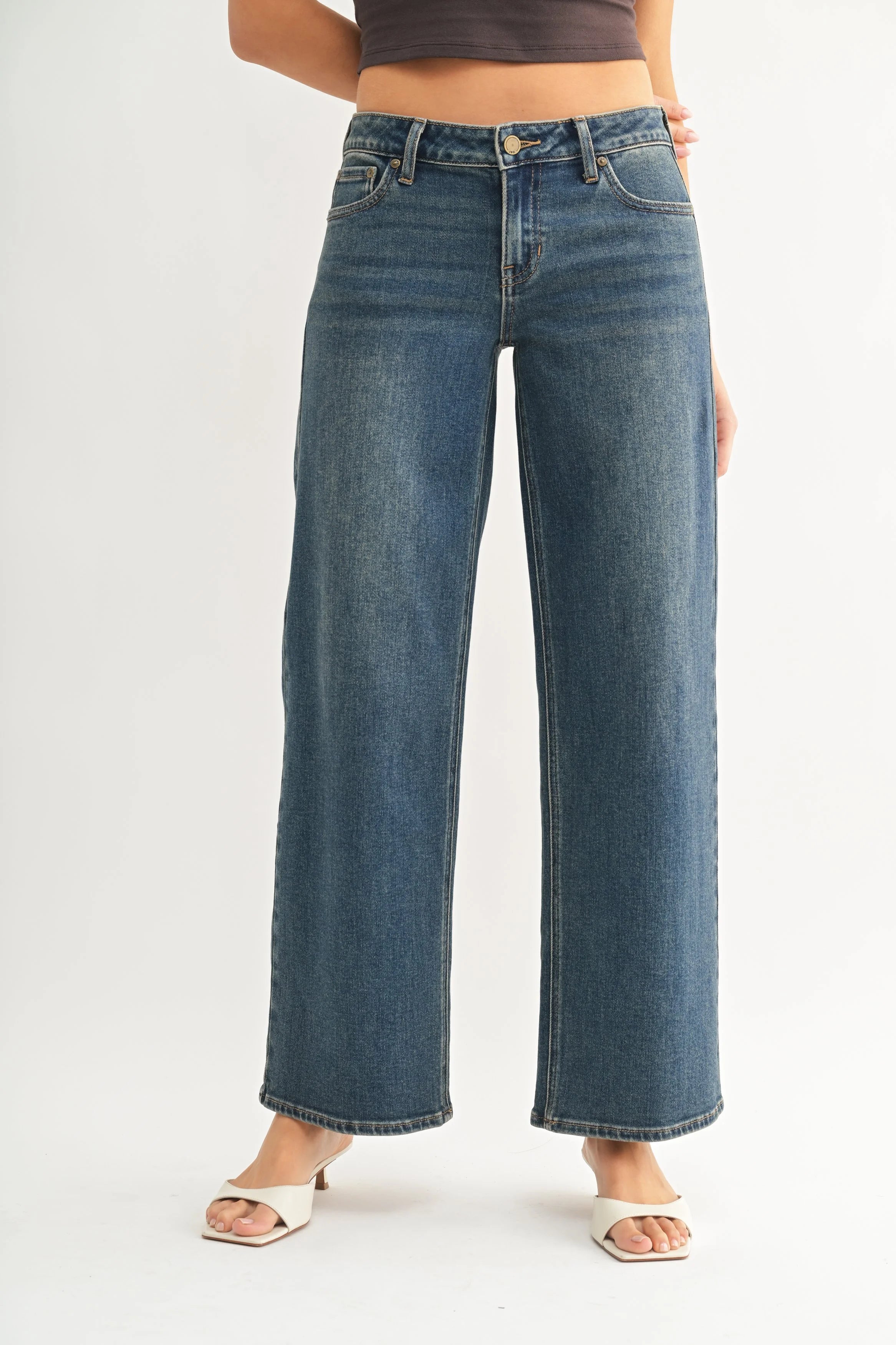 Woman modeling denim on a white background.