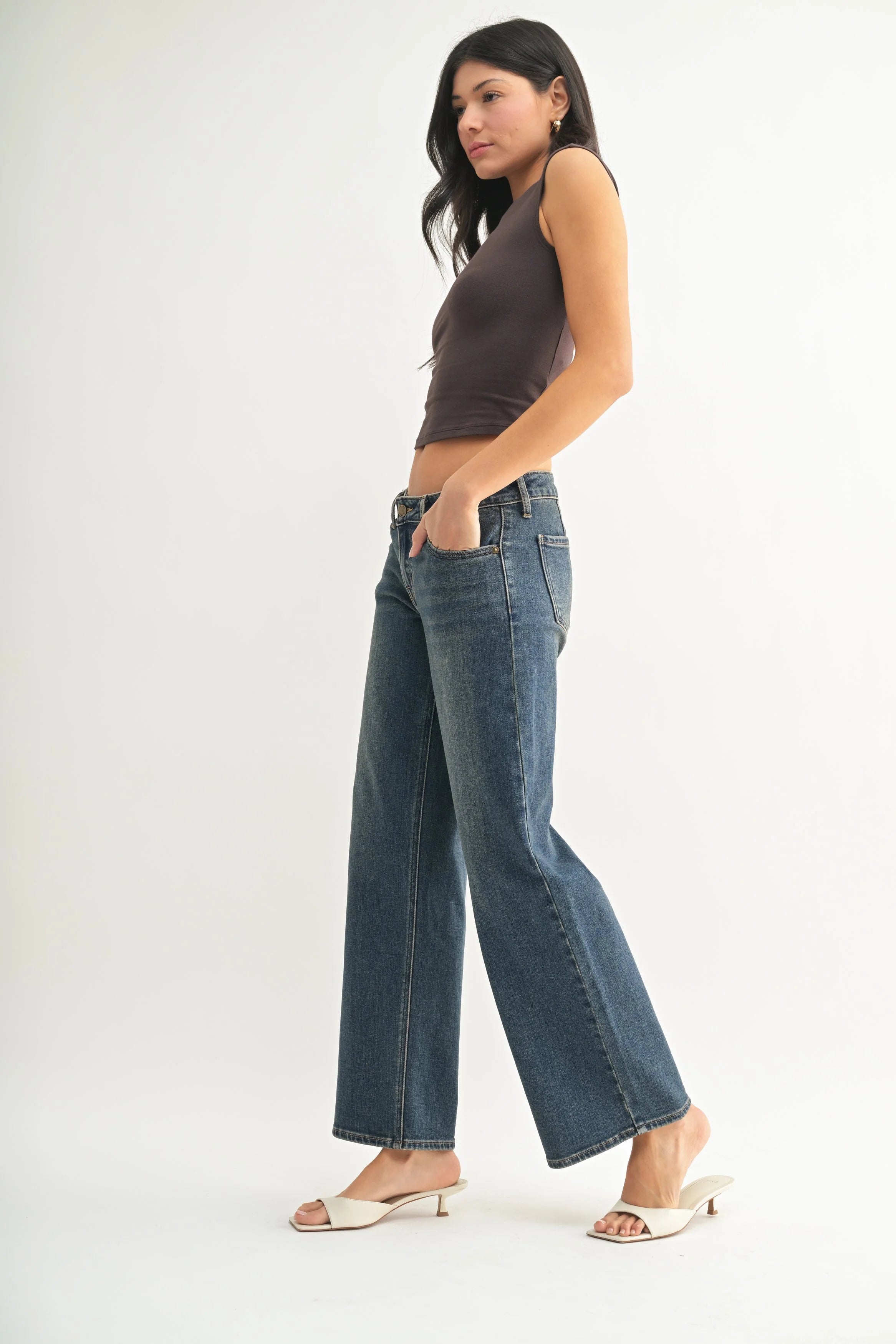 Woman modeling denim on a white background.