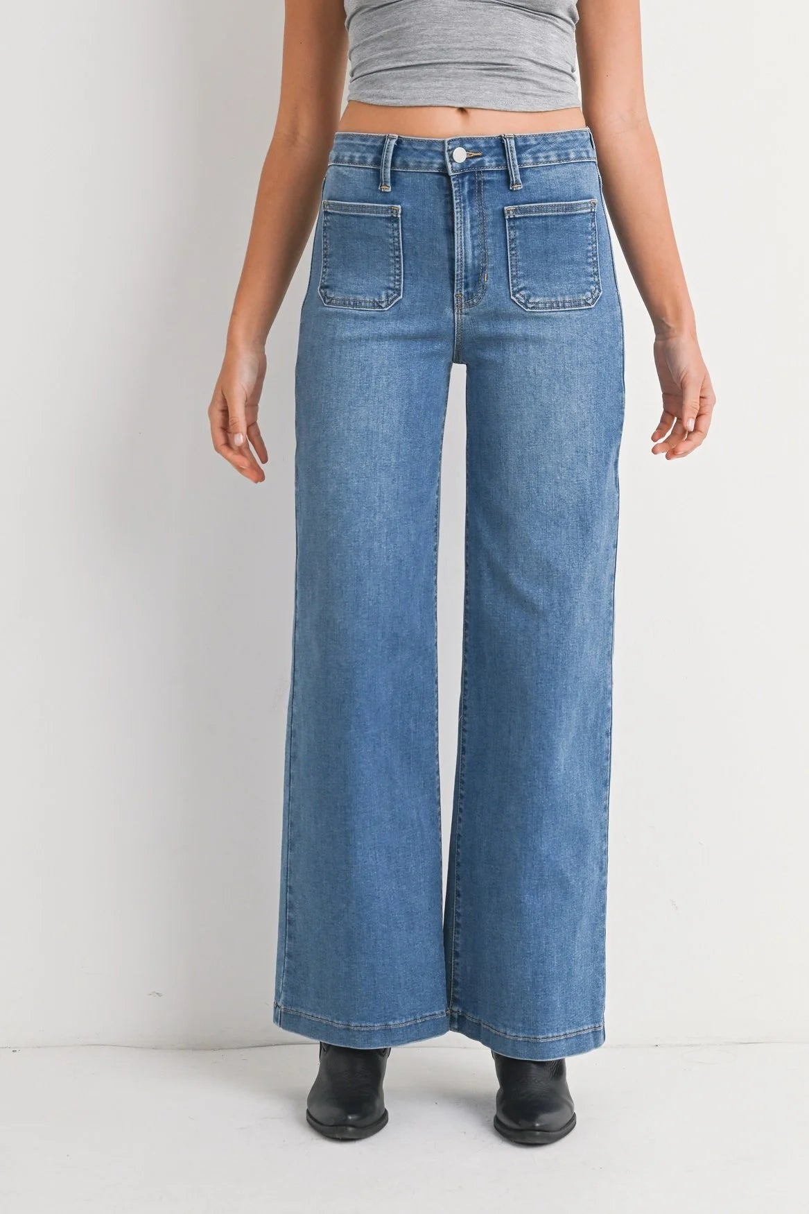Person wearing blue wide-leg jeans on a white background