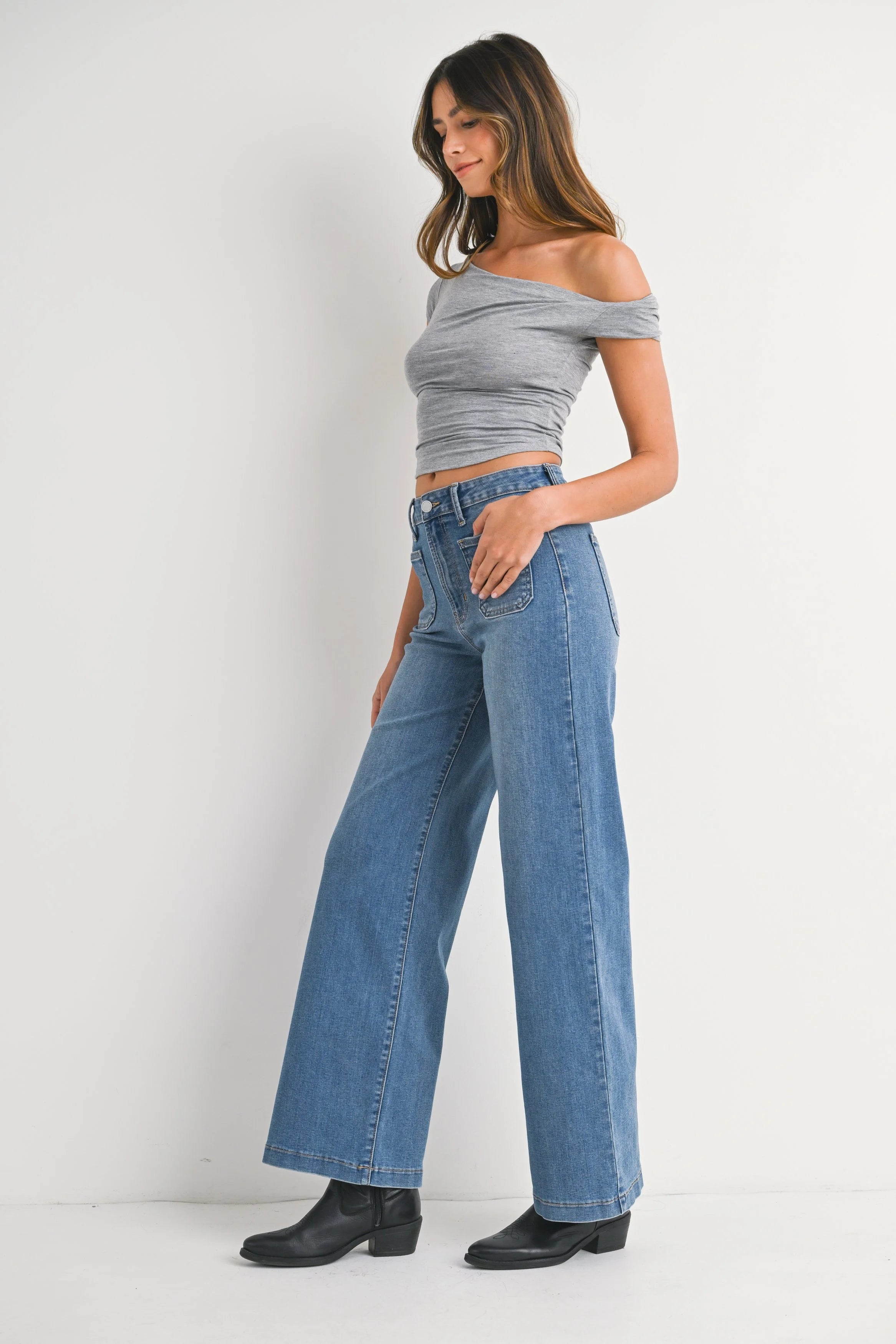 Woman modeling denim on a white background.