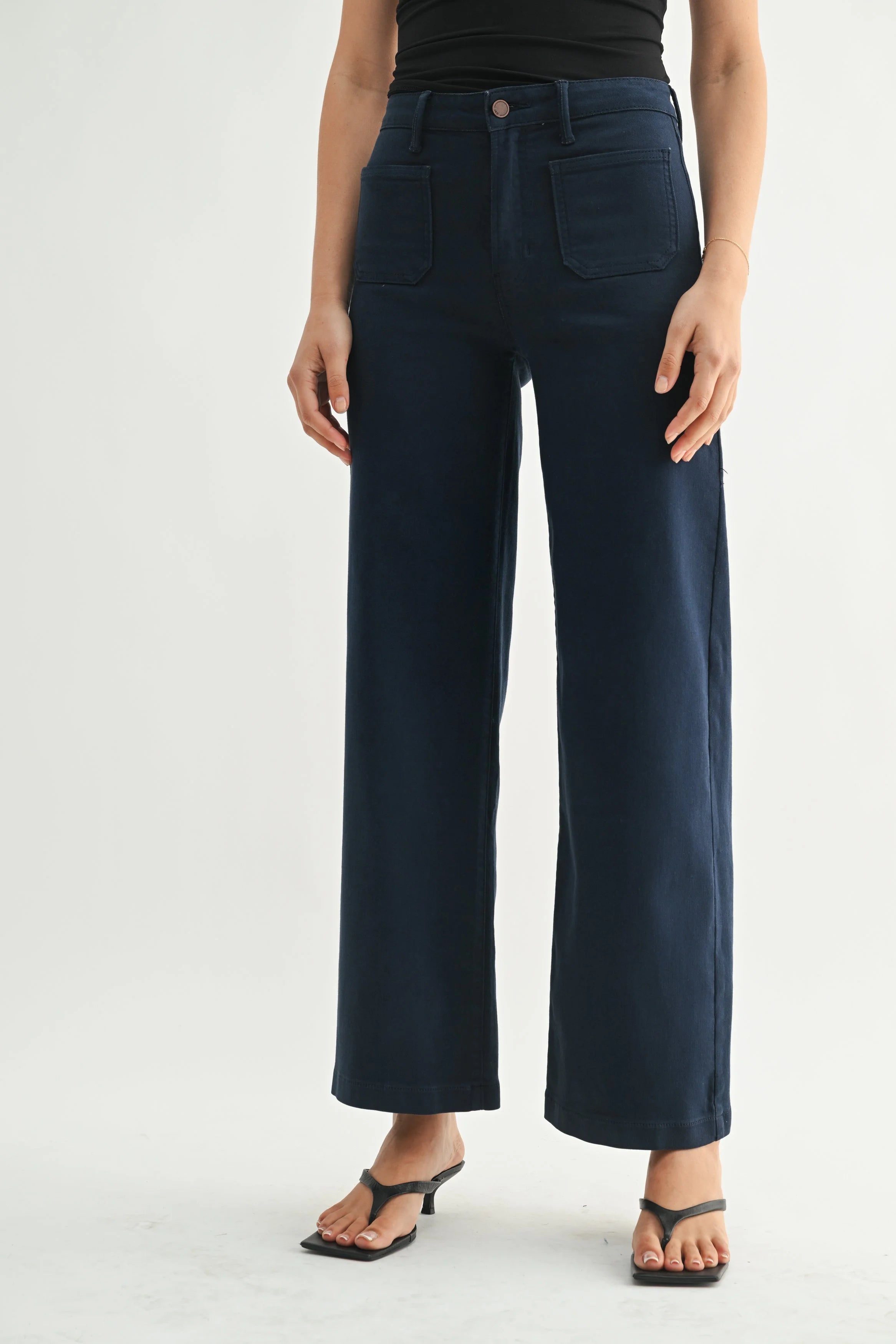 Woman modeling denim on a white background.