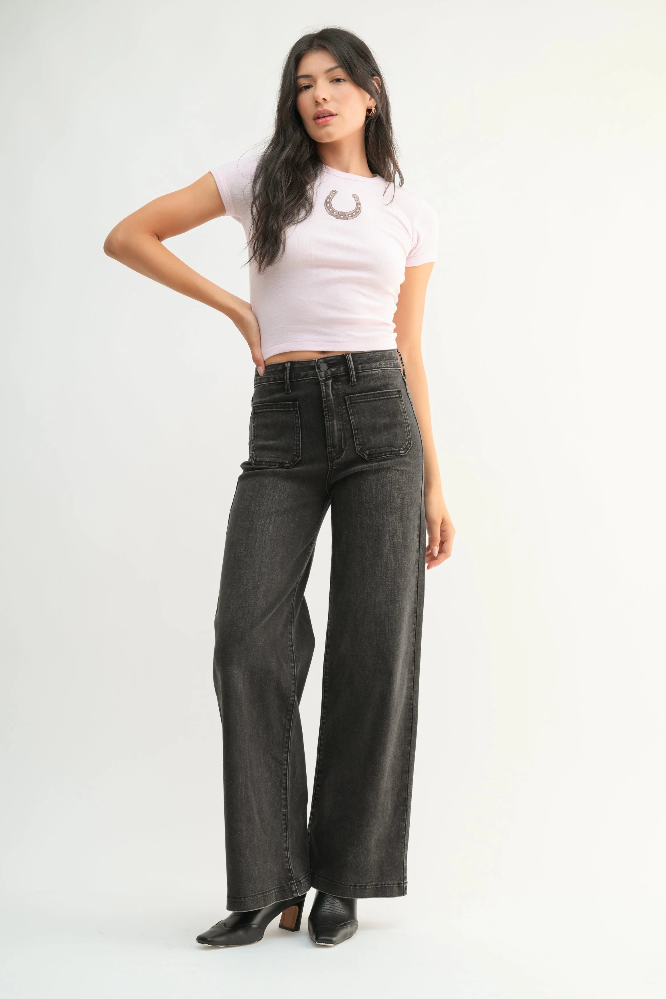 Woman modeling denim on a white background.