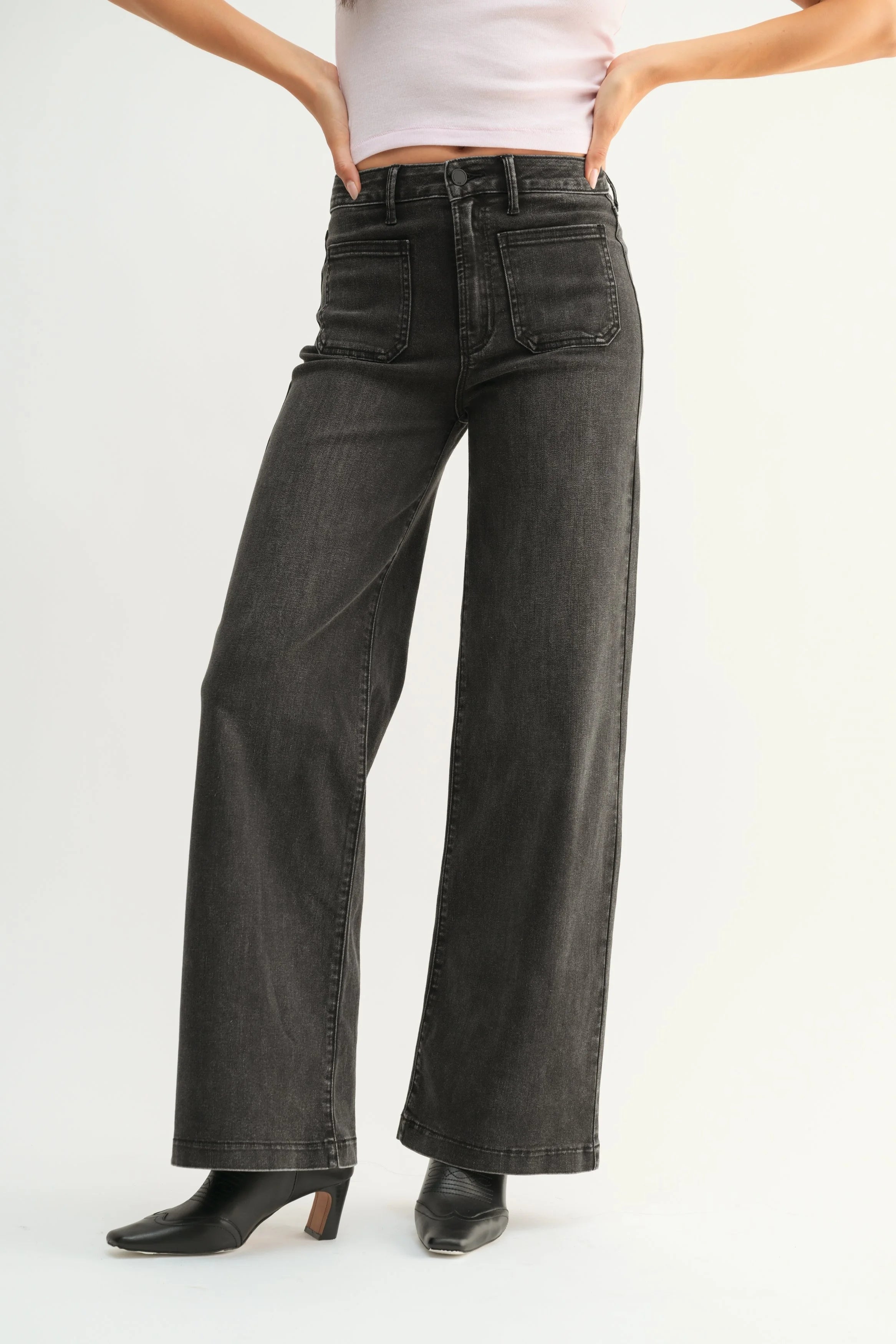 Woman modeling denim on a white background.