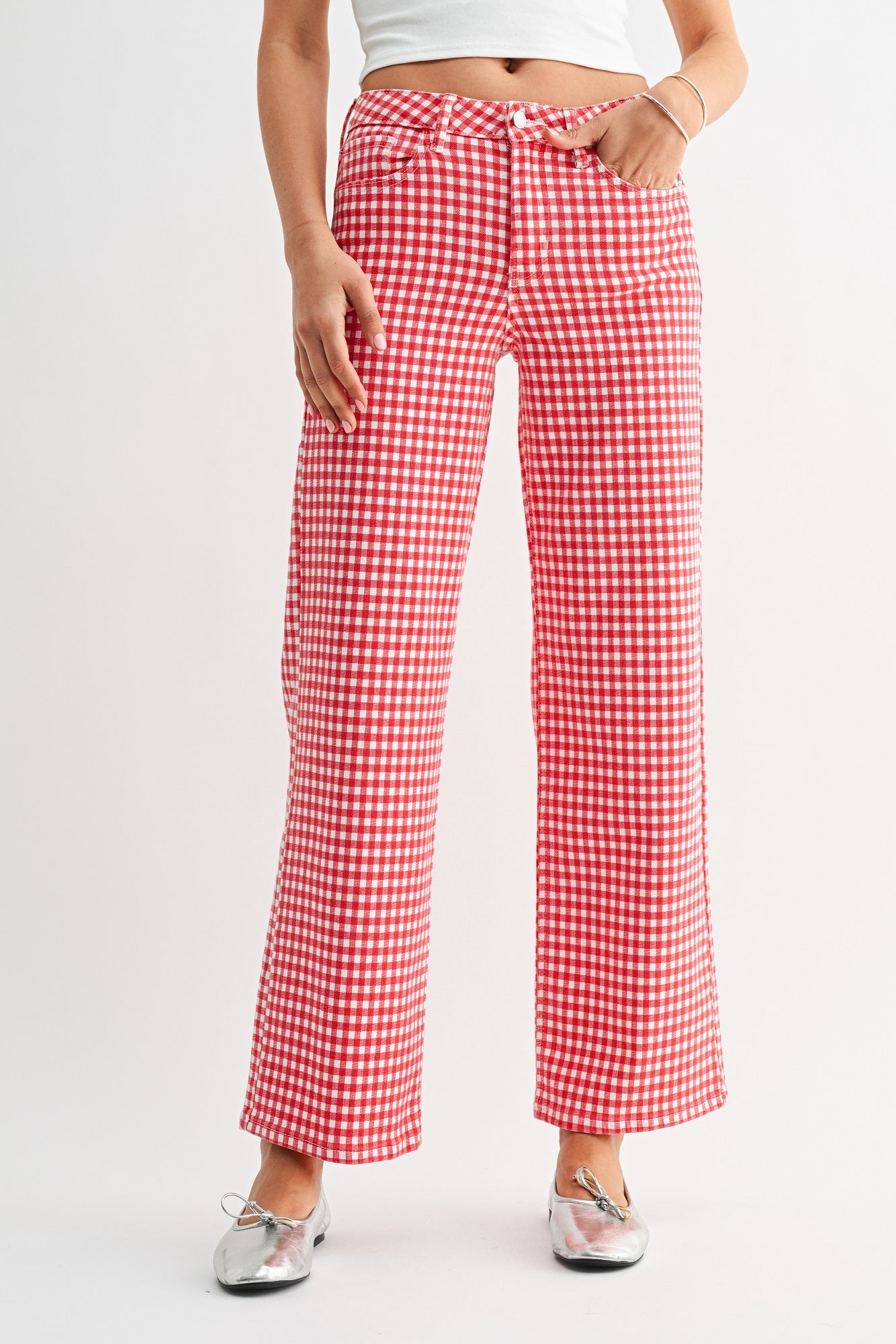 Red and white checkered pants worn by a person on a light gray background