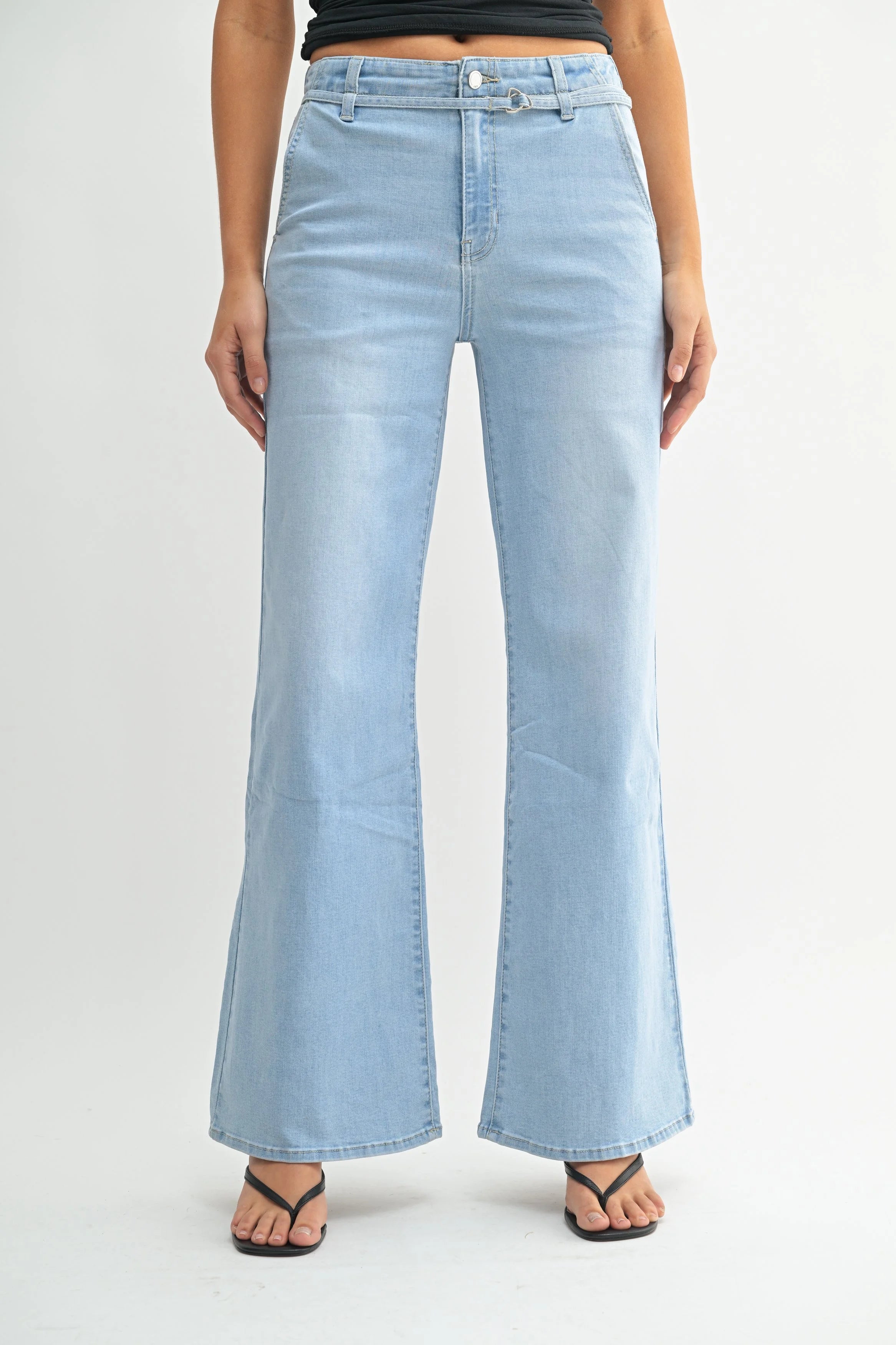 Woman modeling denim on a white background.