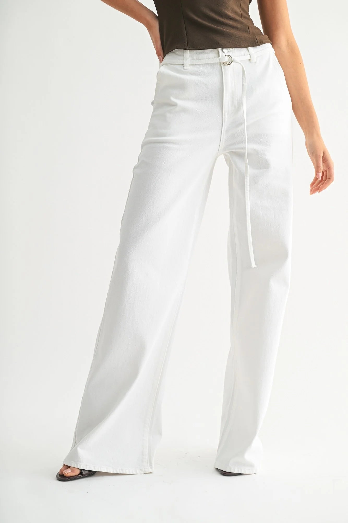 Person wearing white wide-leg pants on a plain background