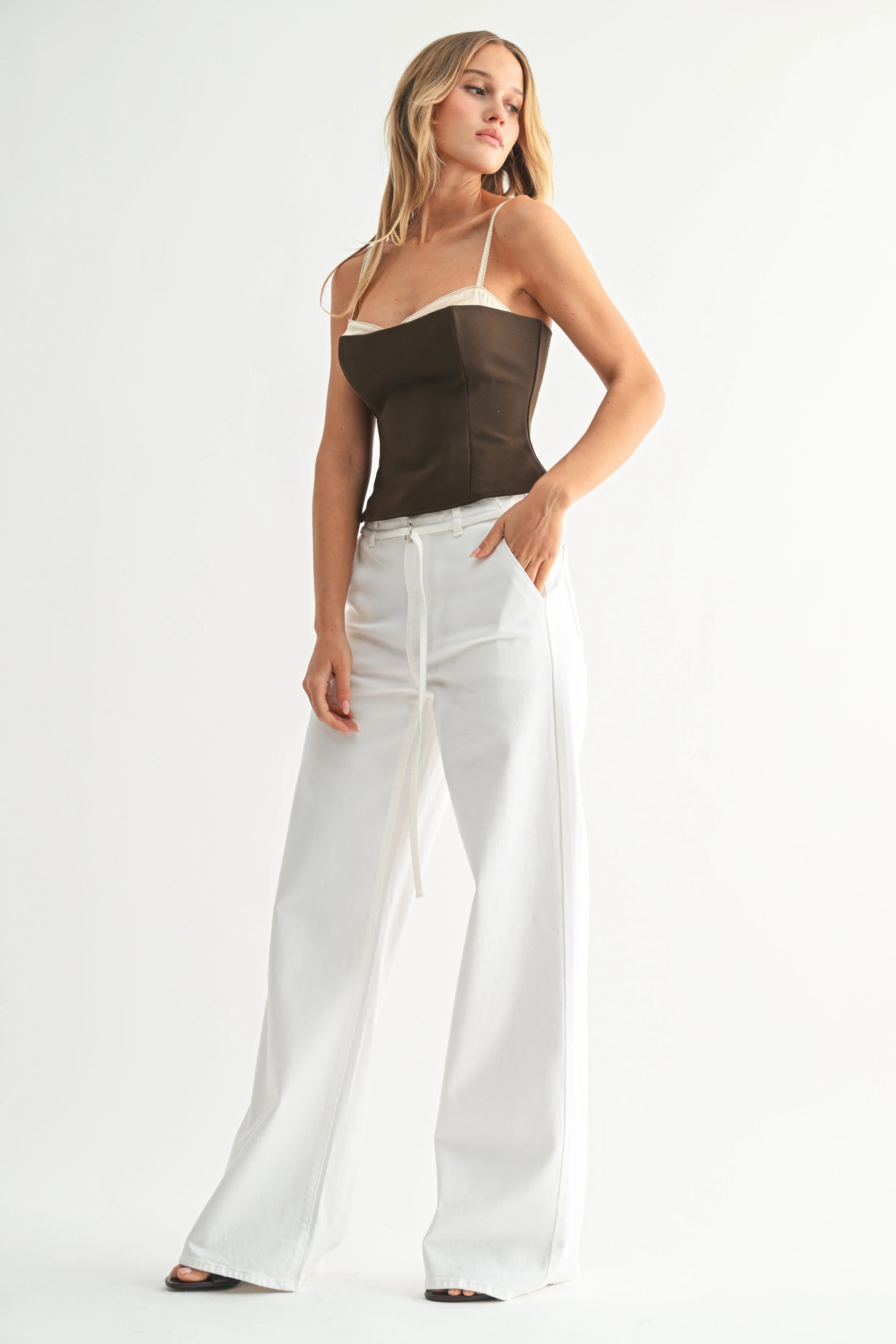 Woman modeling denim on a white background.