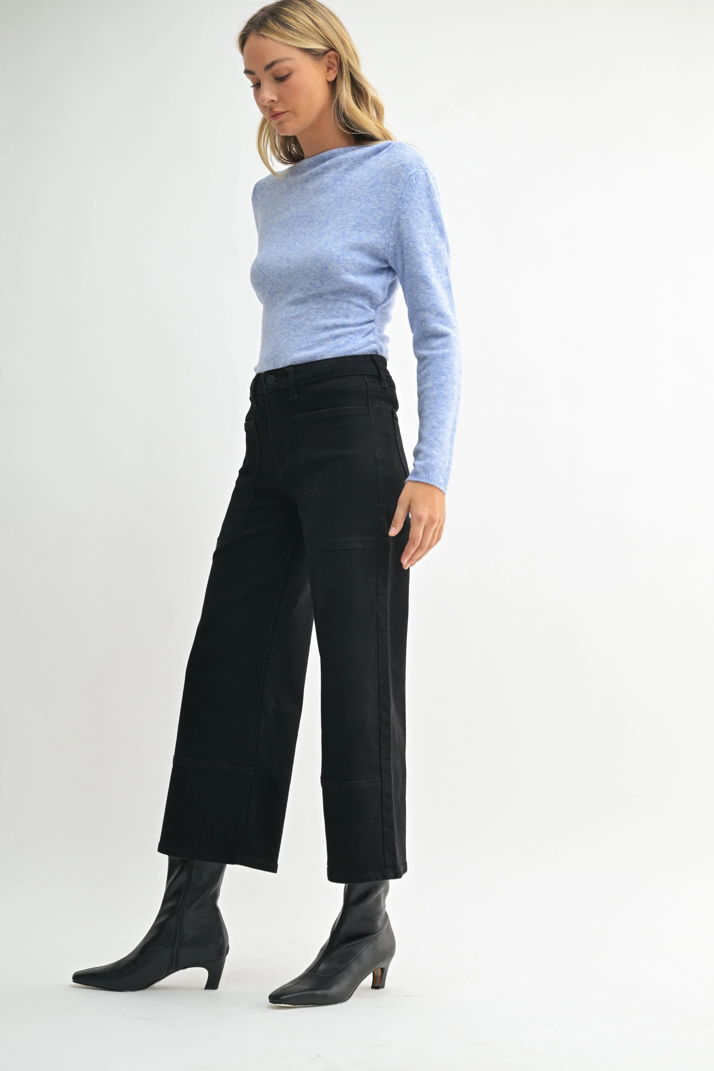 Woman modeling denim on a white background.