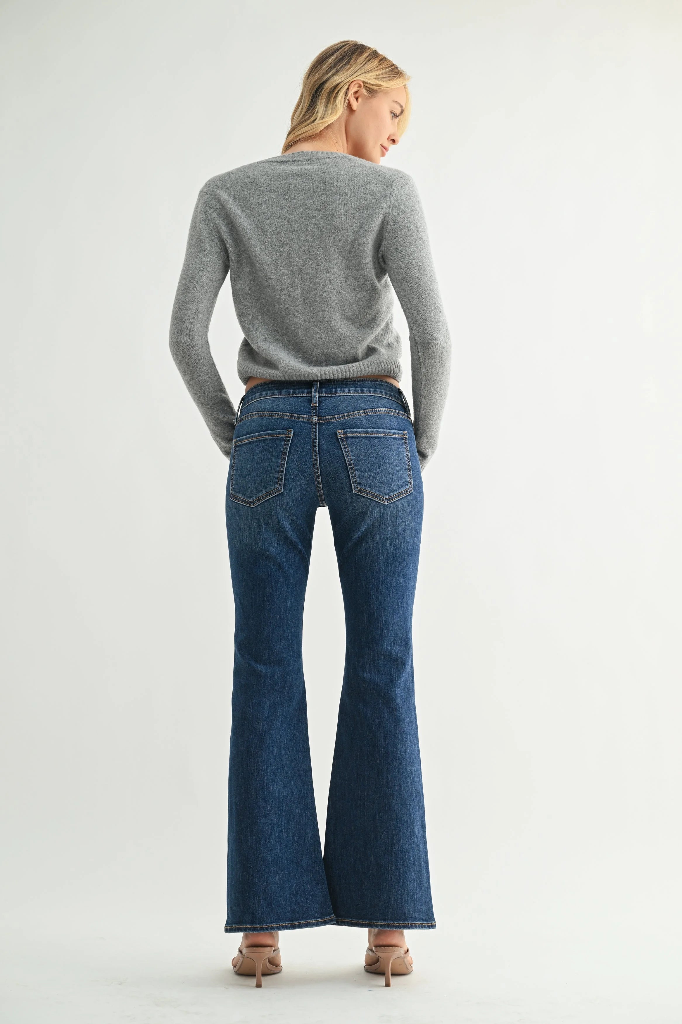 Woman modeling denim on a white background.