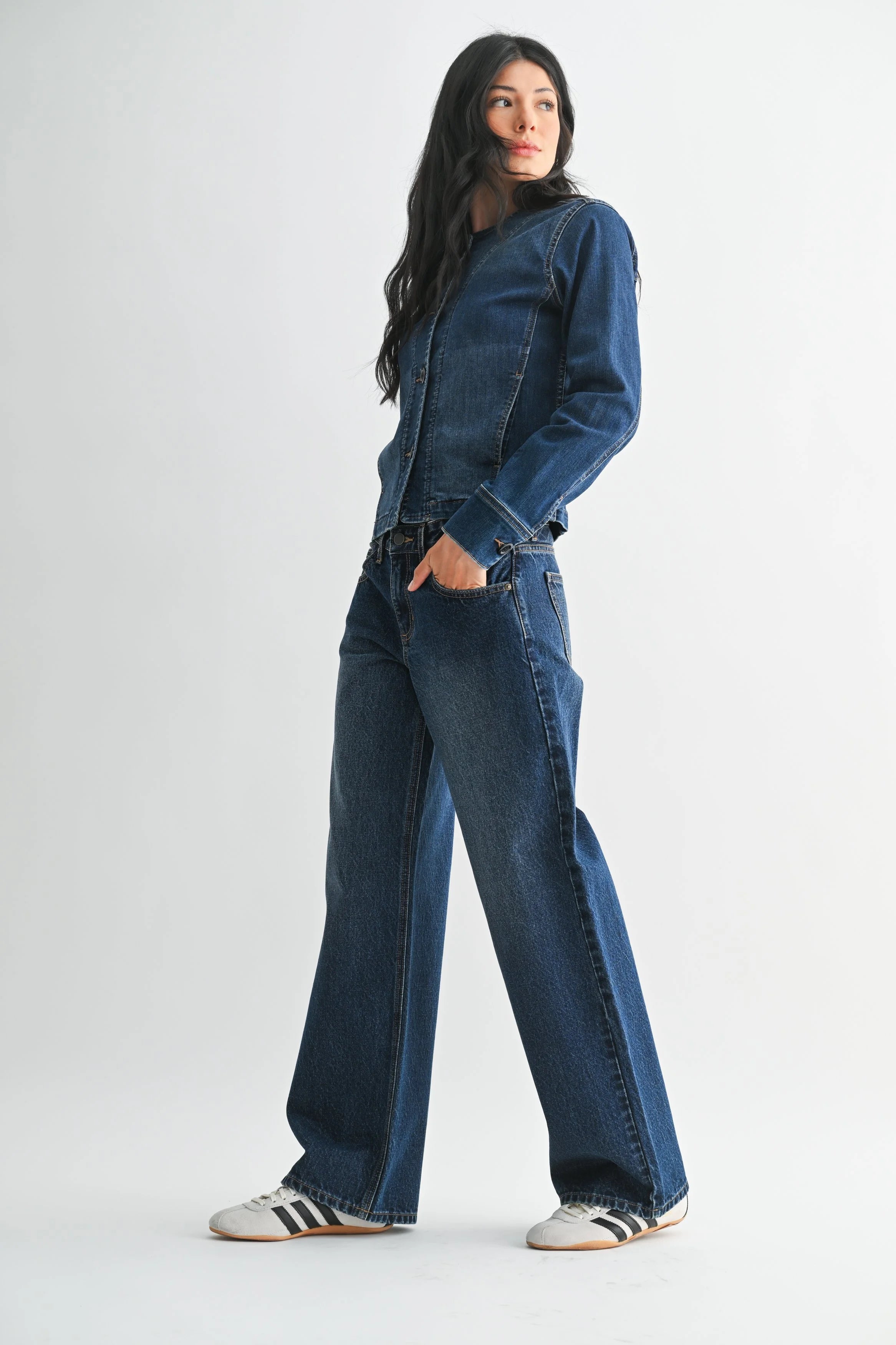 Person wearing a blue denim outfit on a white background