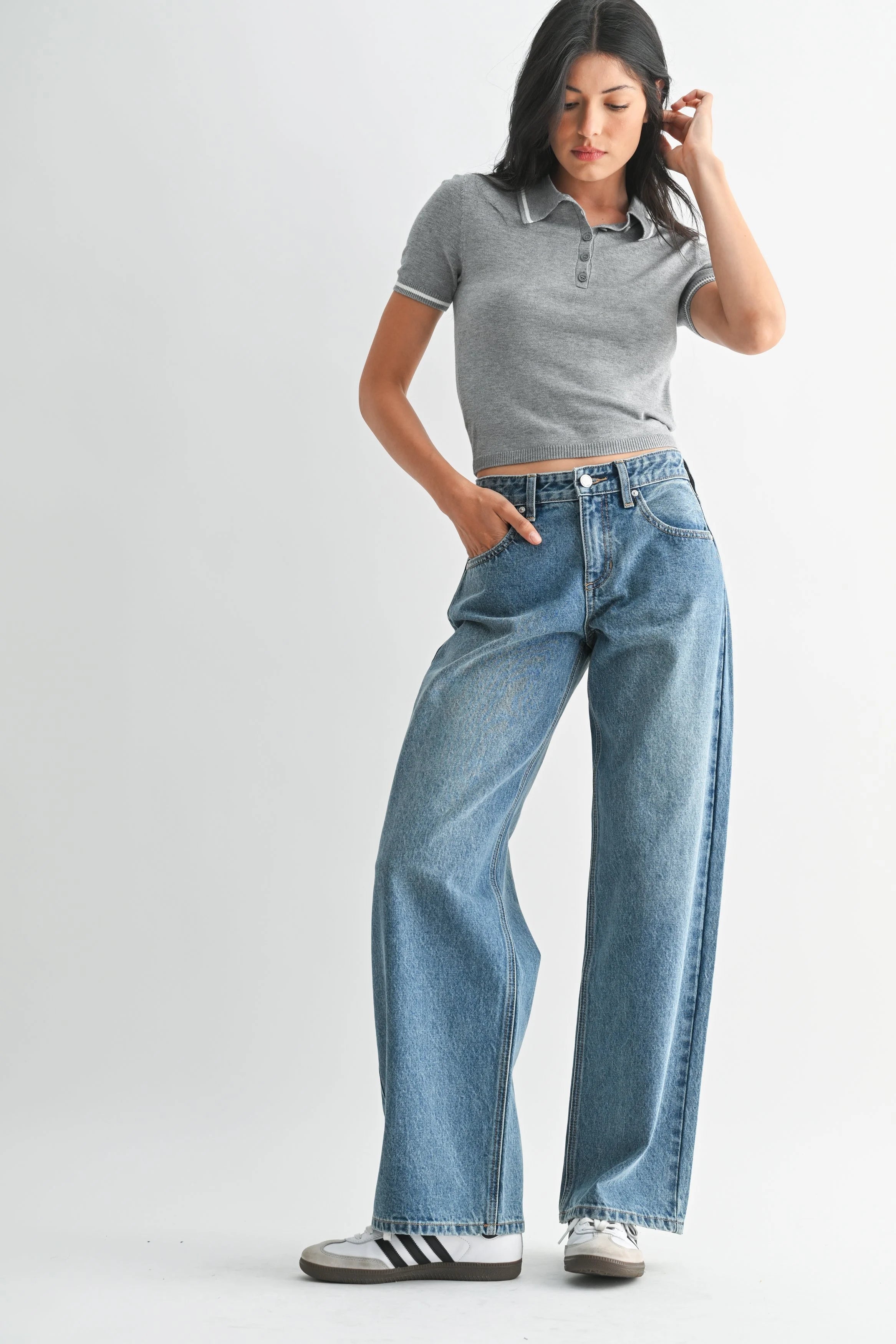 Woman modeling denim on a white background.