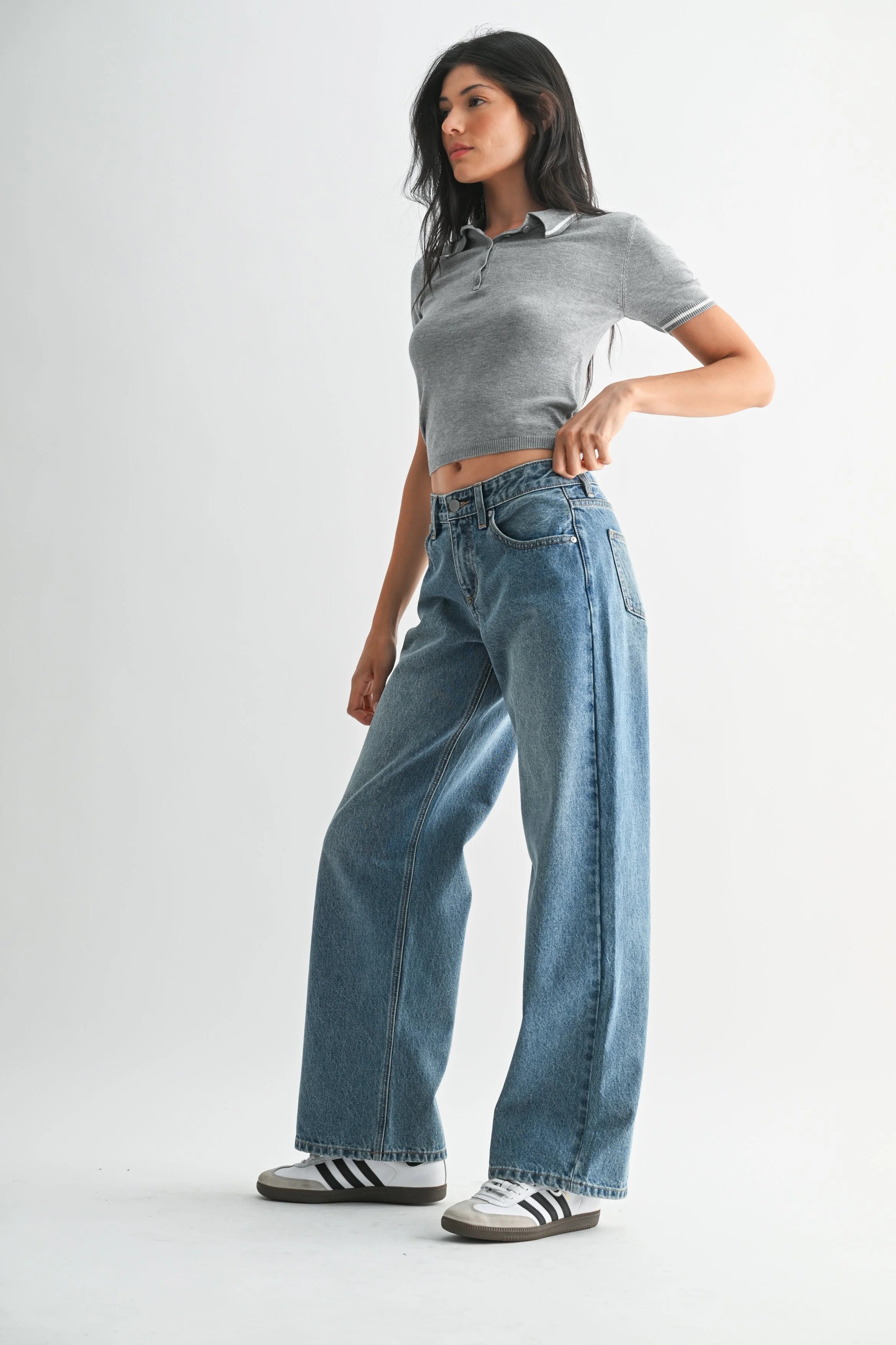 Woman modeling denim on a white background.