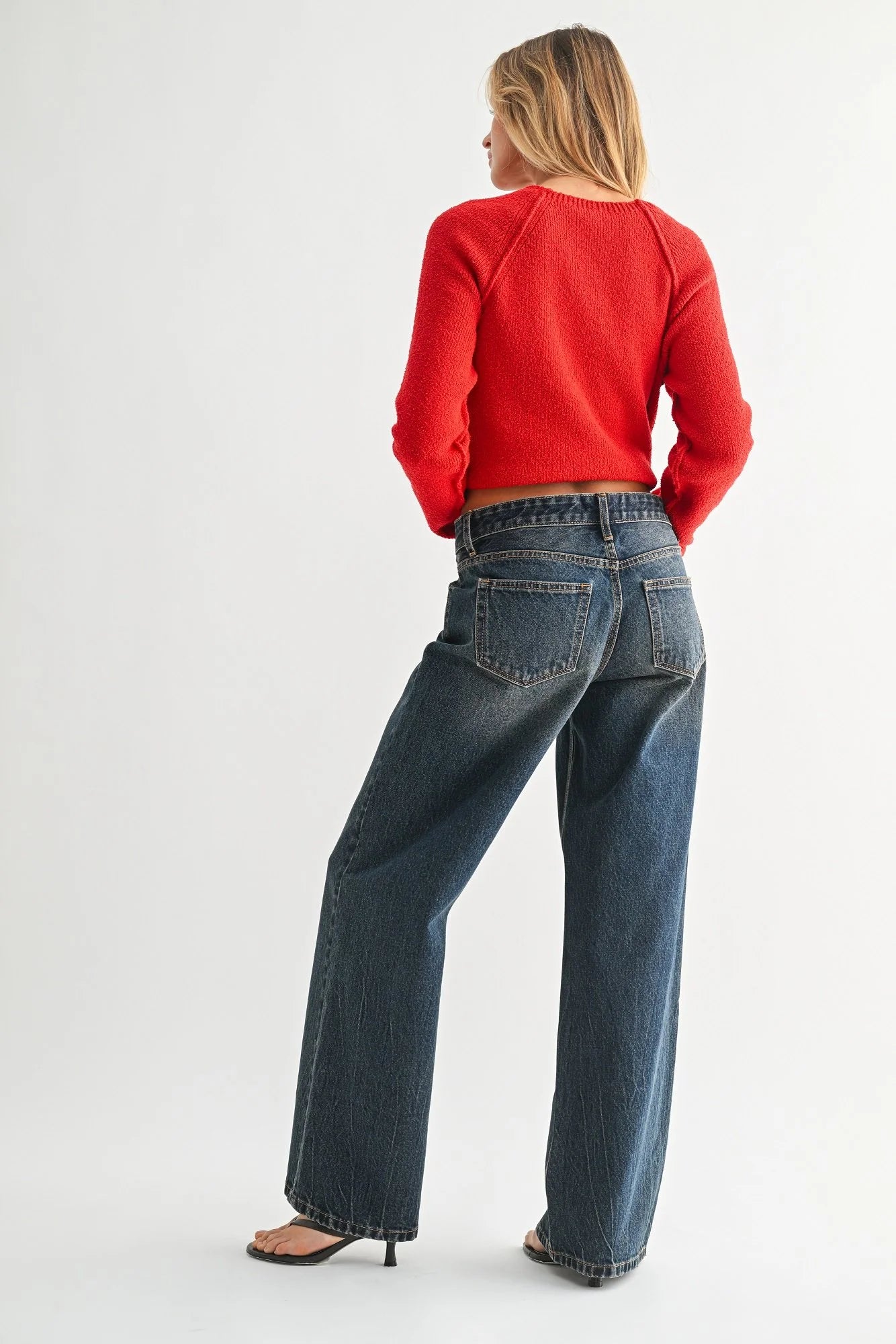 Woman modeling denim on a white background.