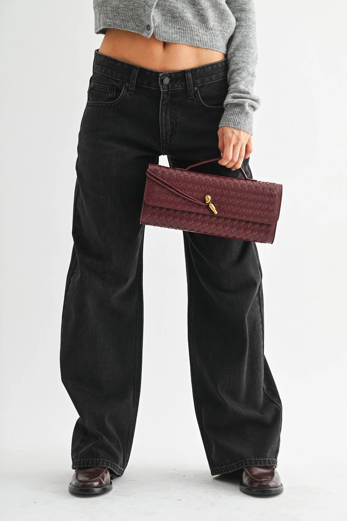 Woman modeling denim on a white background.