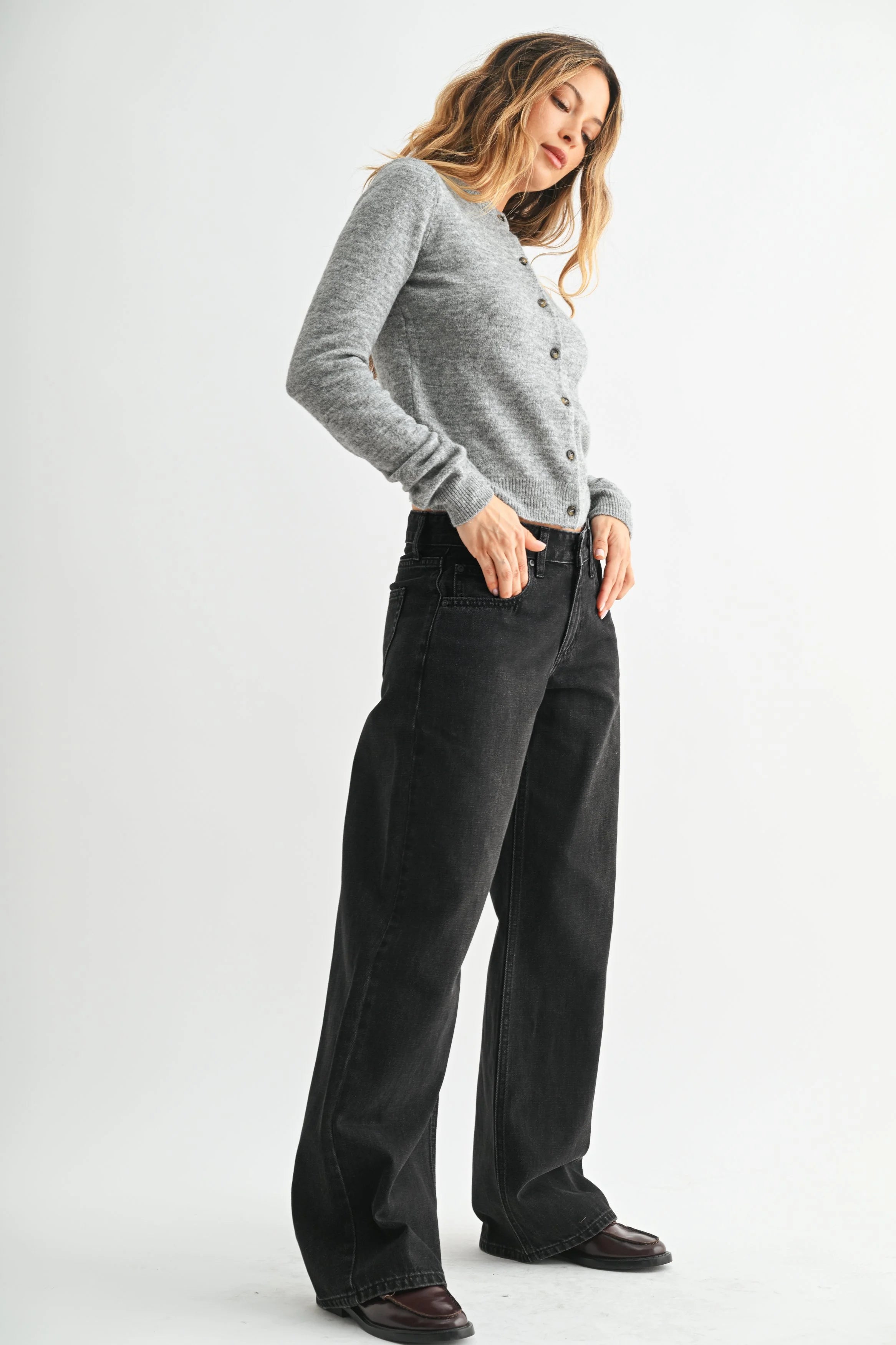 Woman modeling denim on a white background.