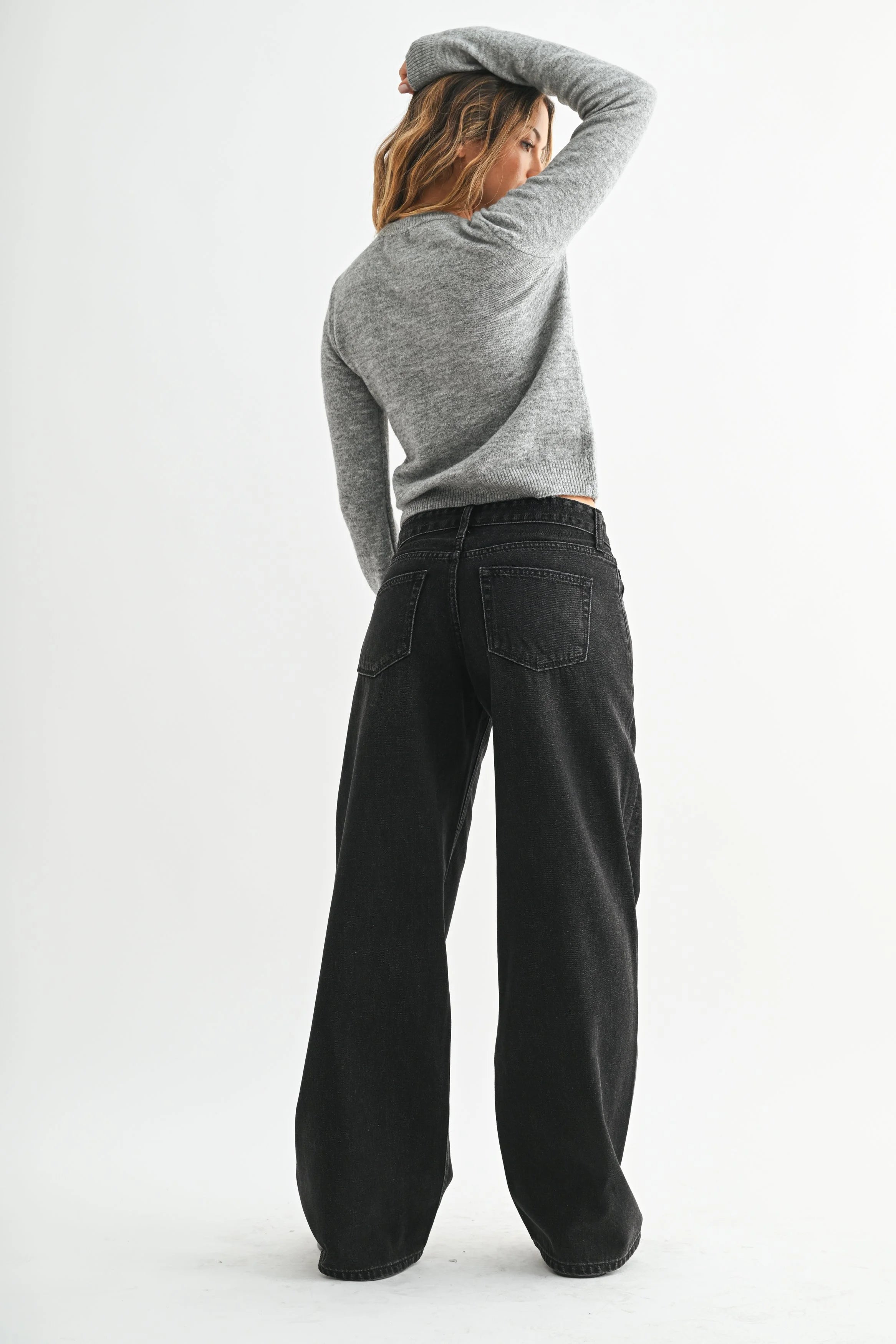 Woman modeling denim on a white background.