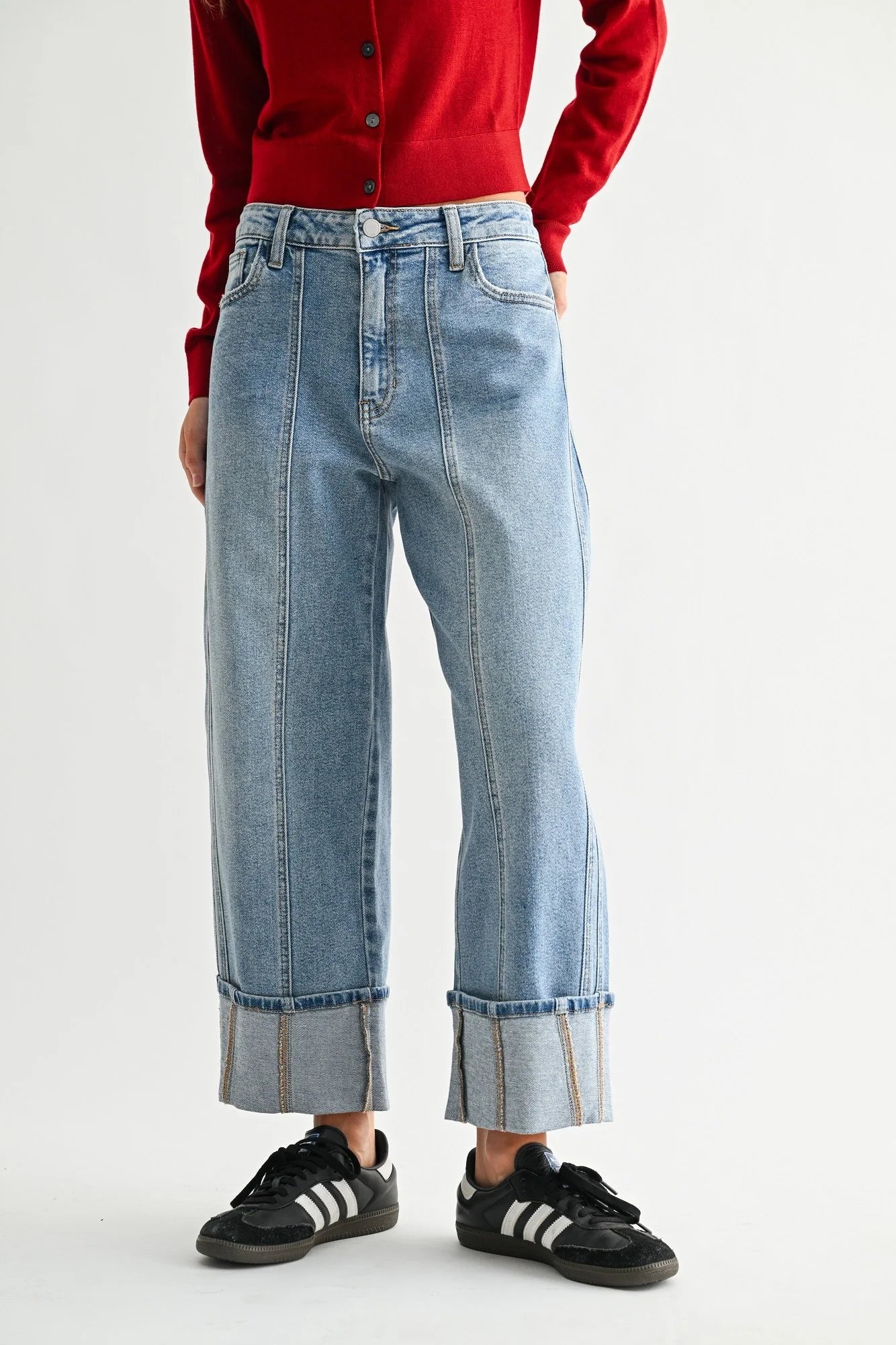 Woman modeling denim on a white background.