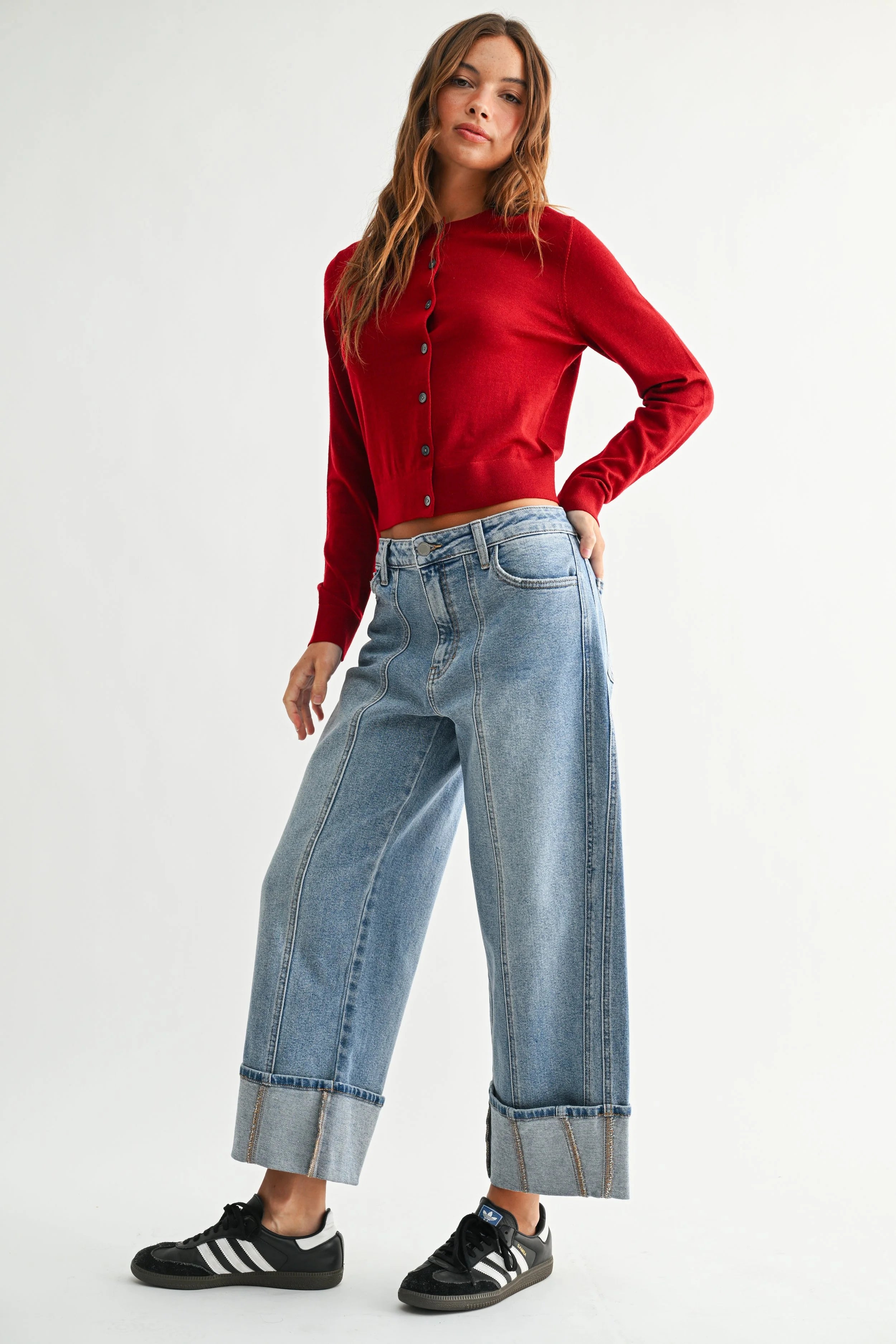 Woman modeling denim on a white background.