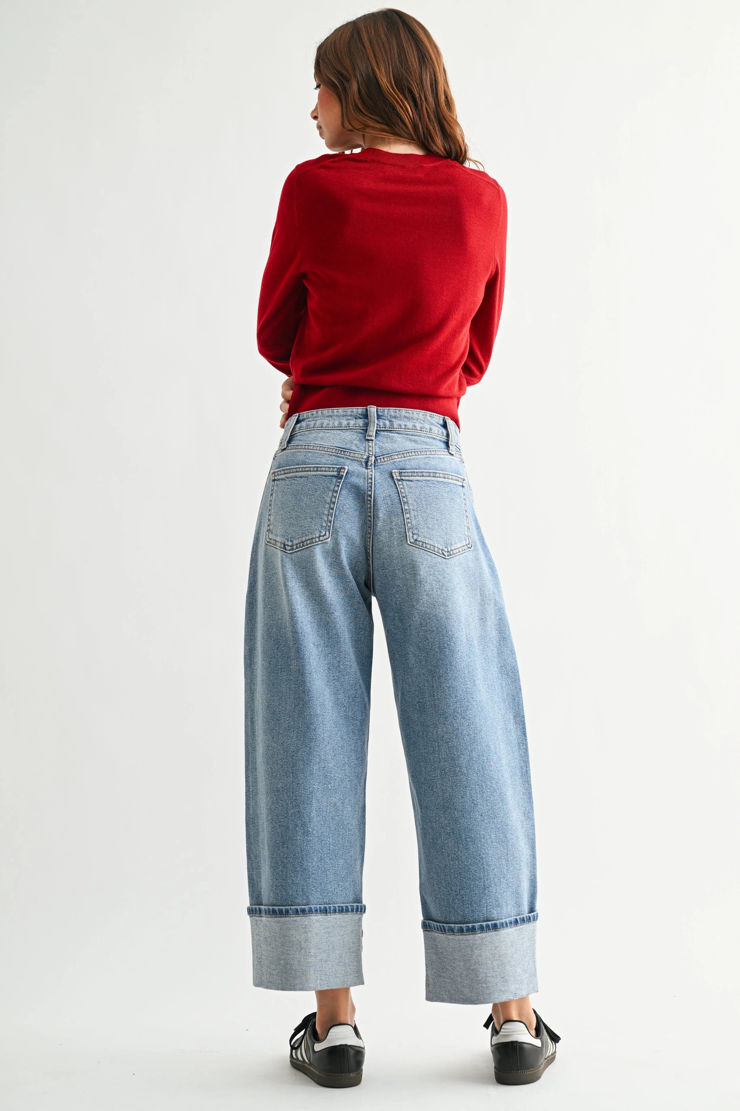 Woman modeling denim on a white background.