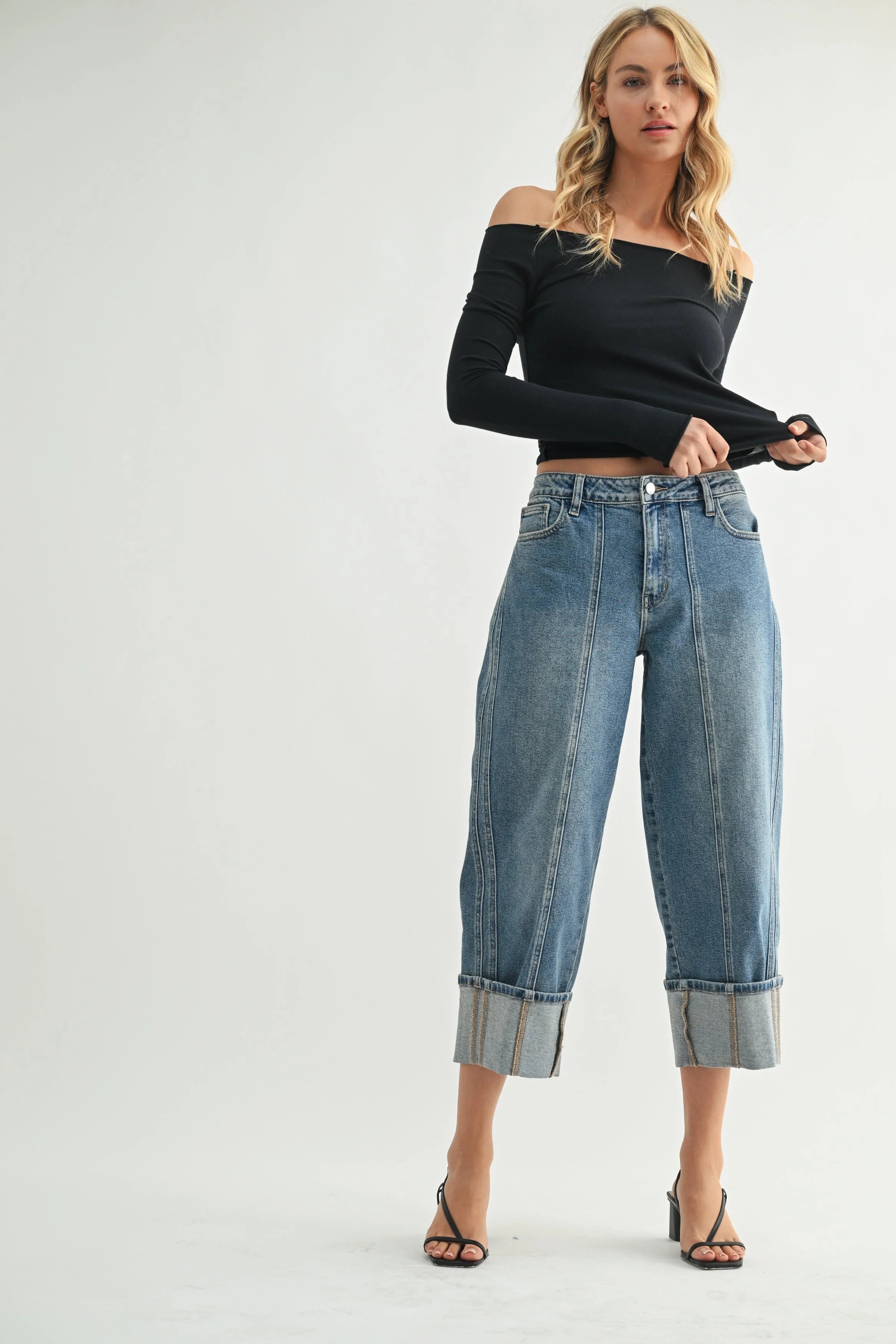 Woman modeling denim on a white background.