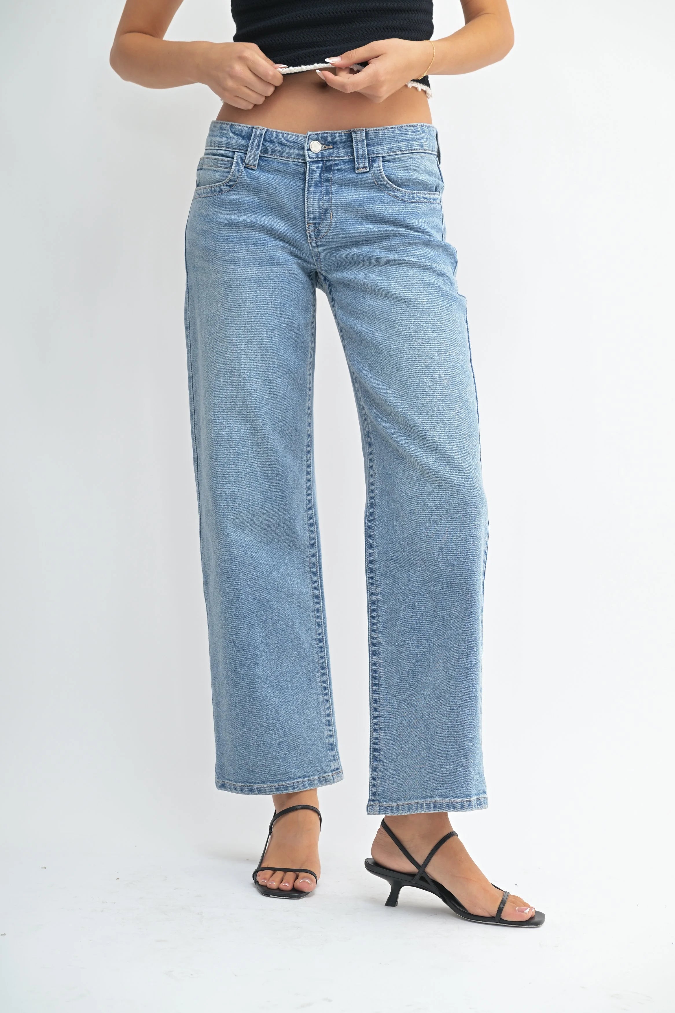 Light blue jeans worn by a person on a white background