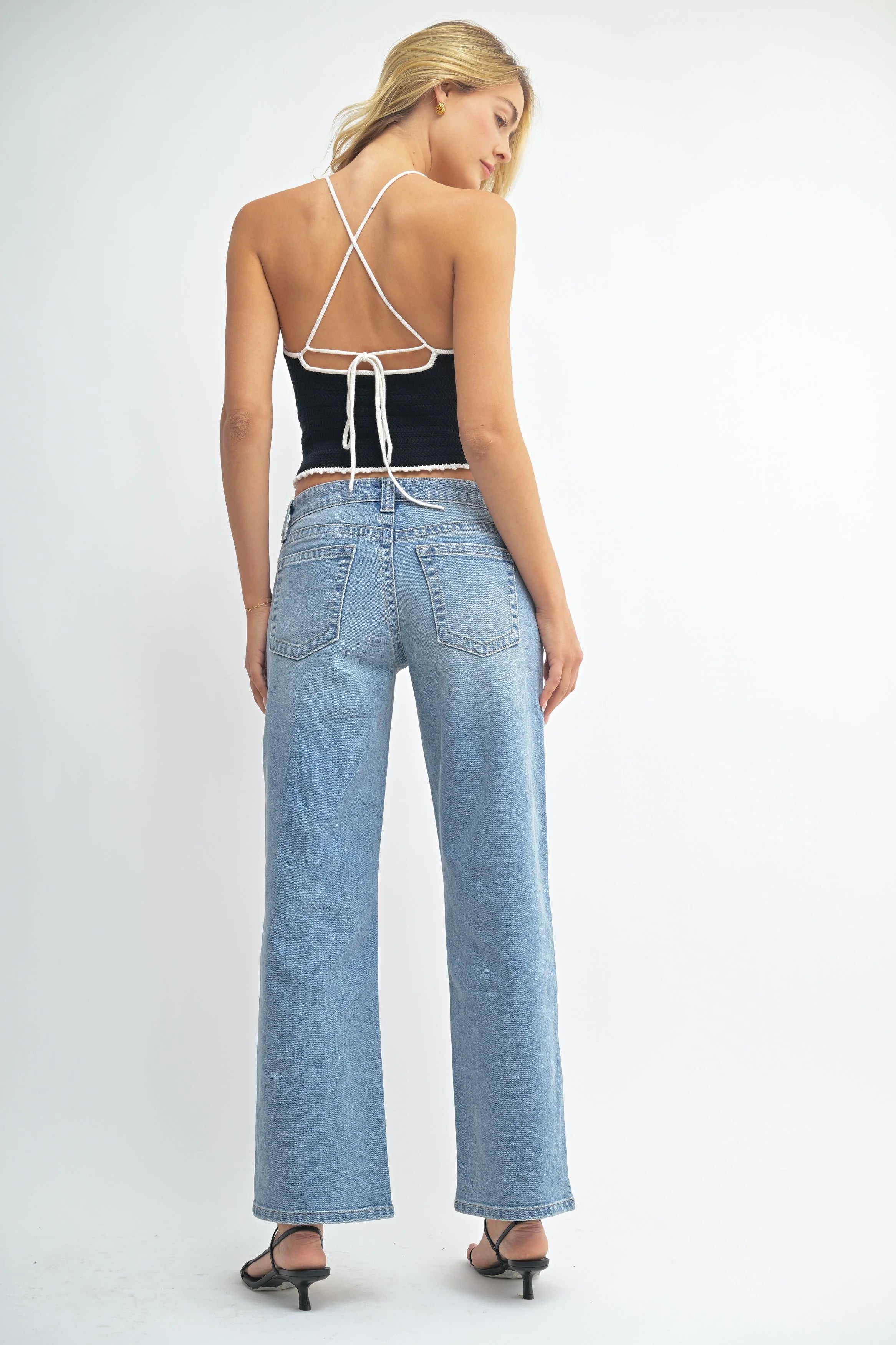 Woman modeling denim on a white background.