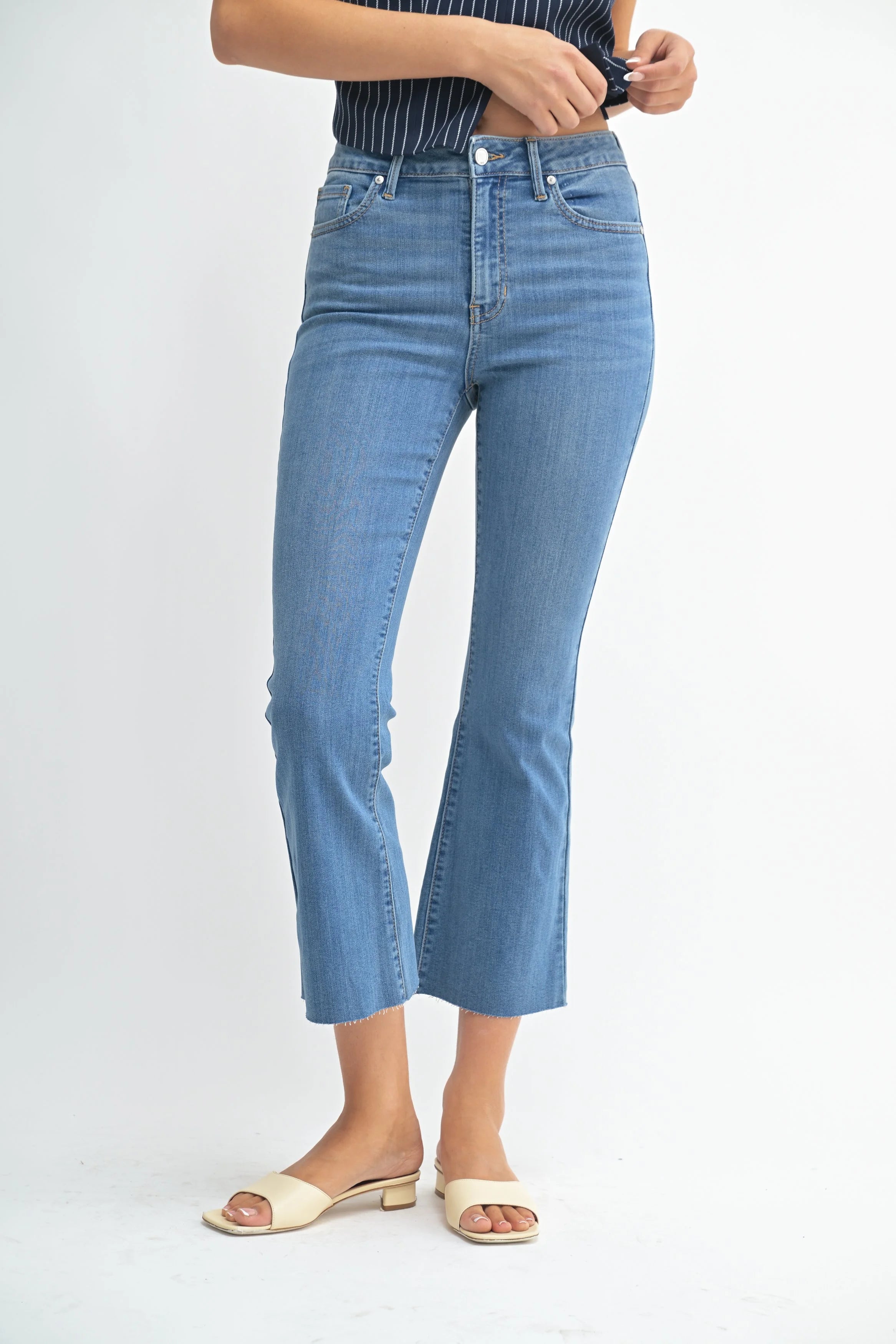 Person wearing blue jeans on a white background